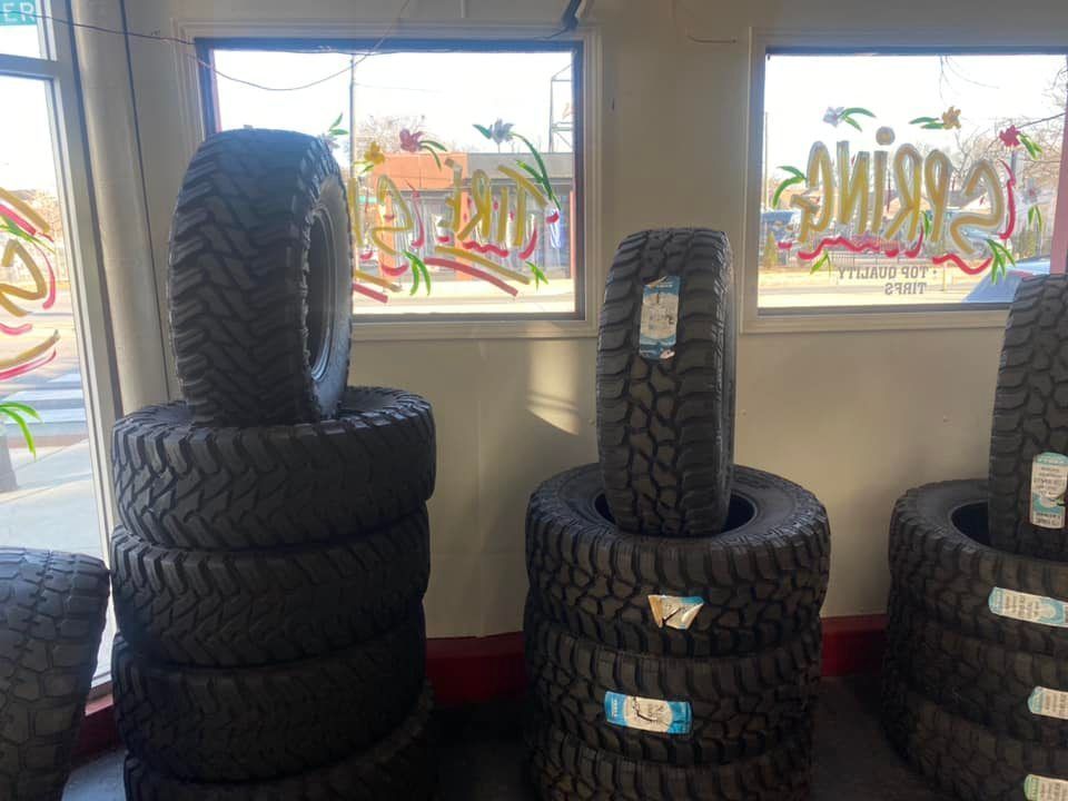 A bunch of tires are stacked on top of each other in a store.