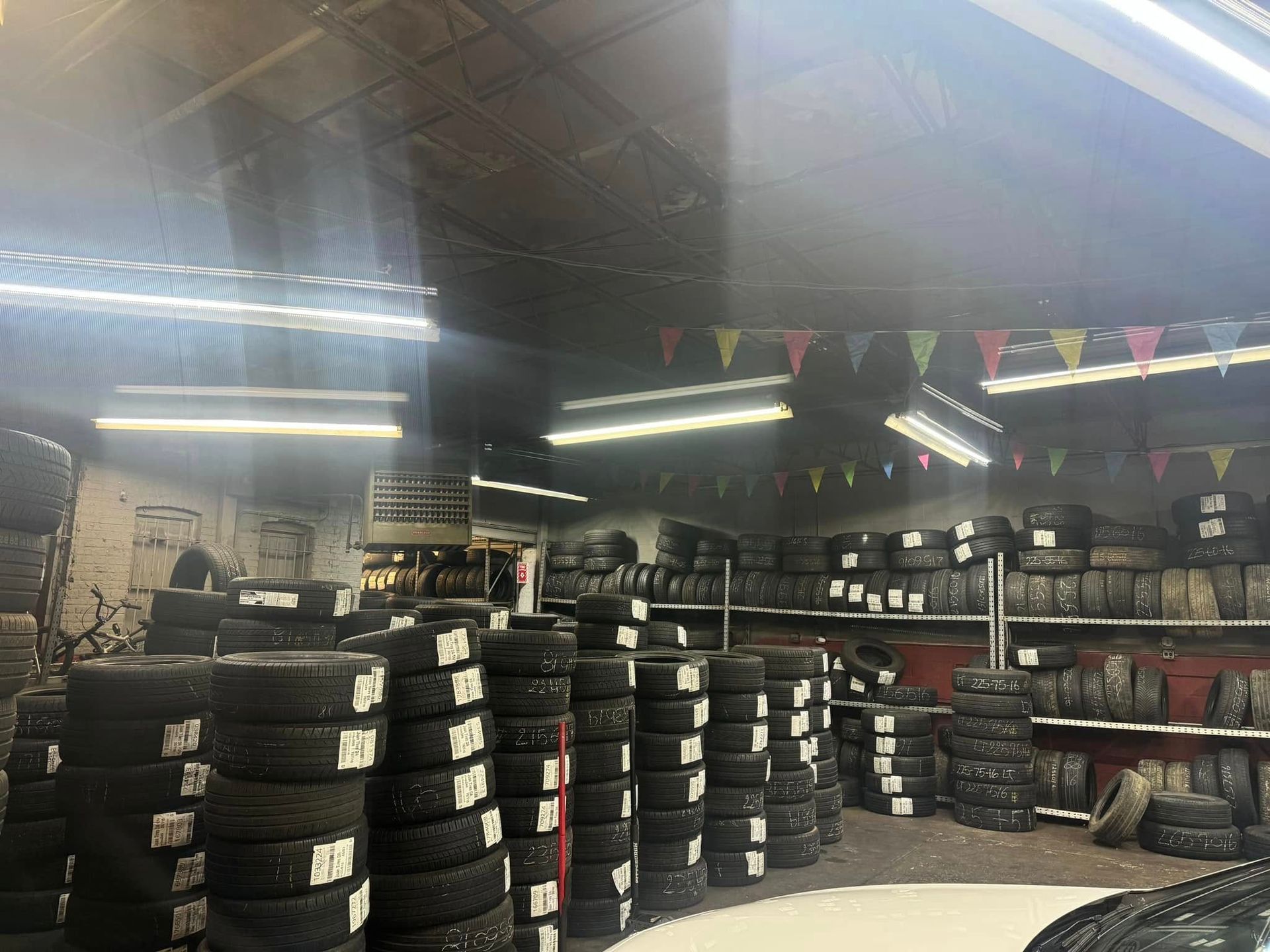 A warehouse filled with lots of tires and flags