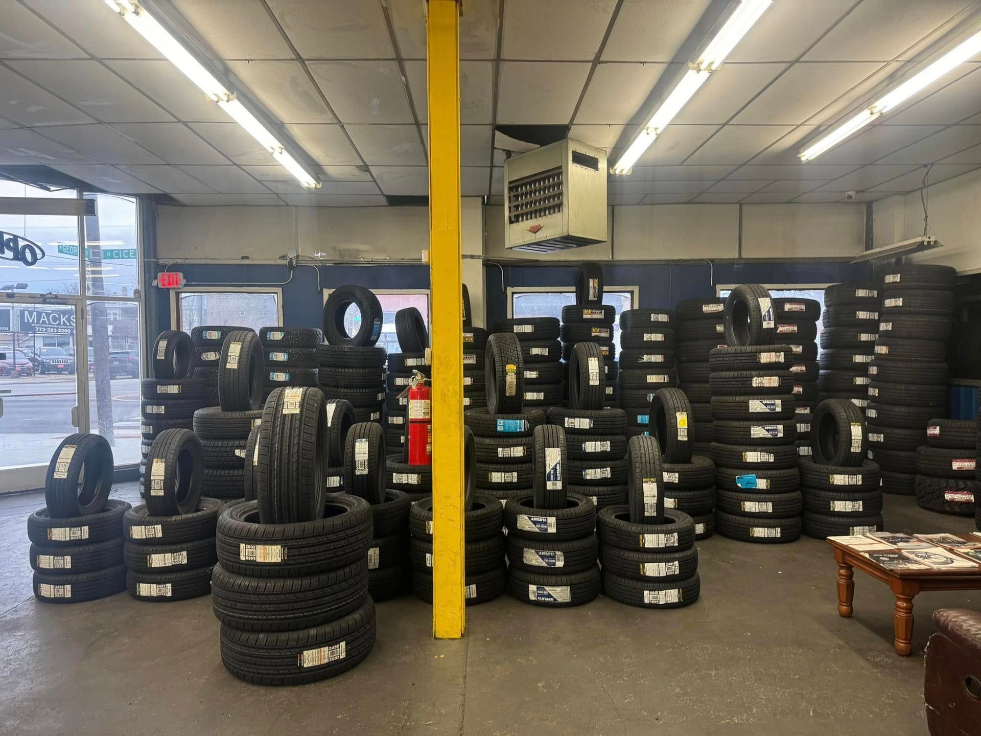 A store filled with lots of tires and a fire extinguisher.