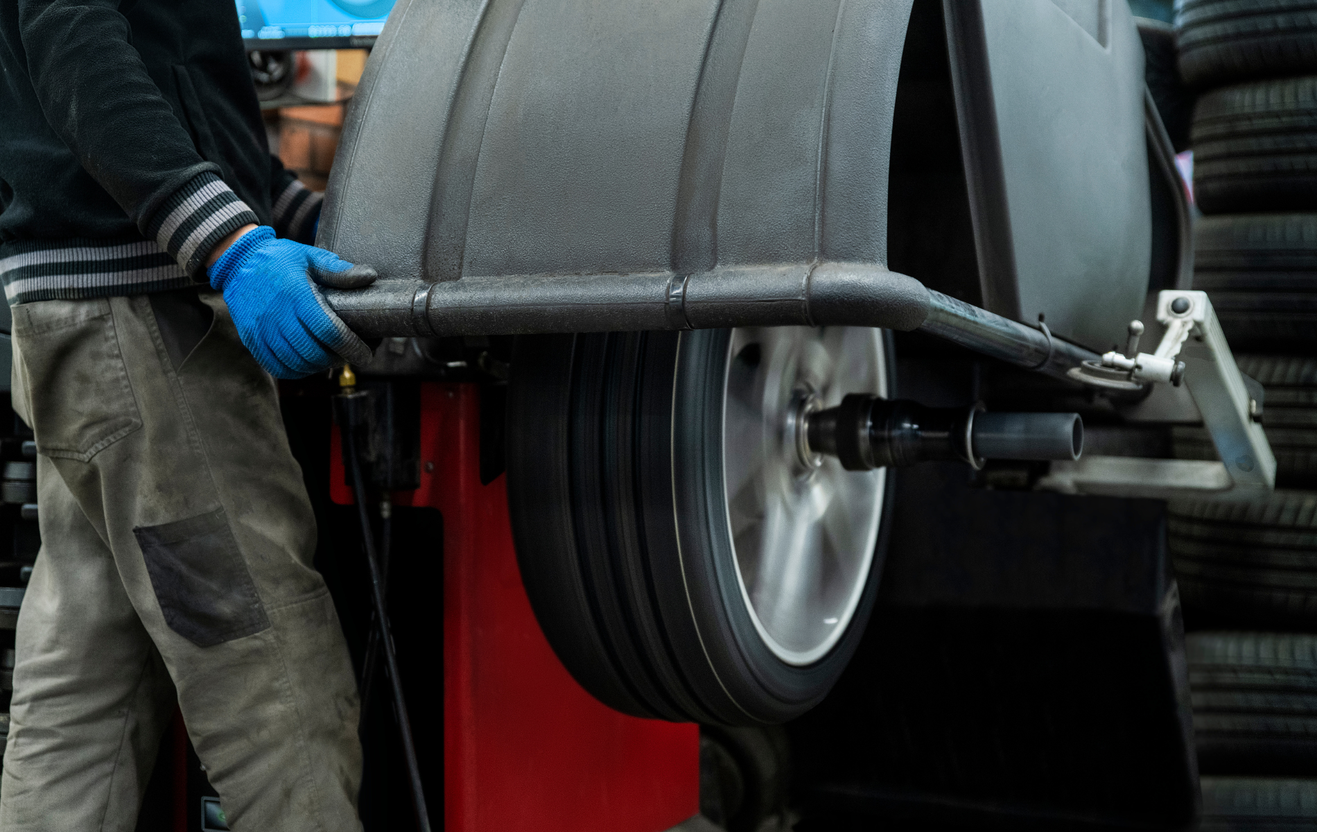 A man is balancing a tire on a machine.