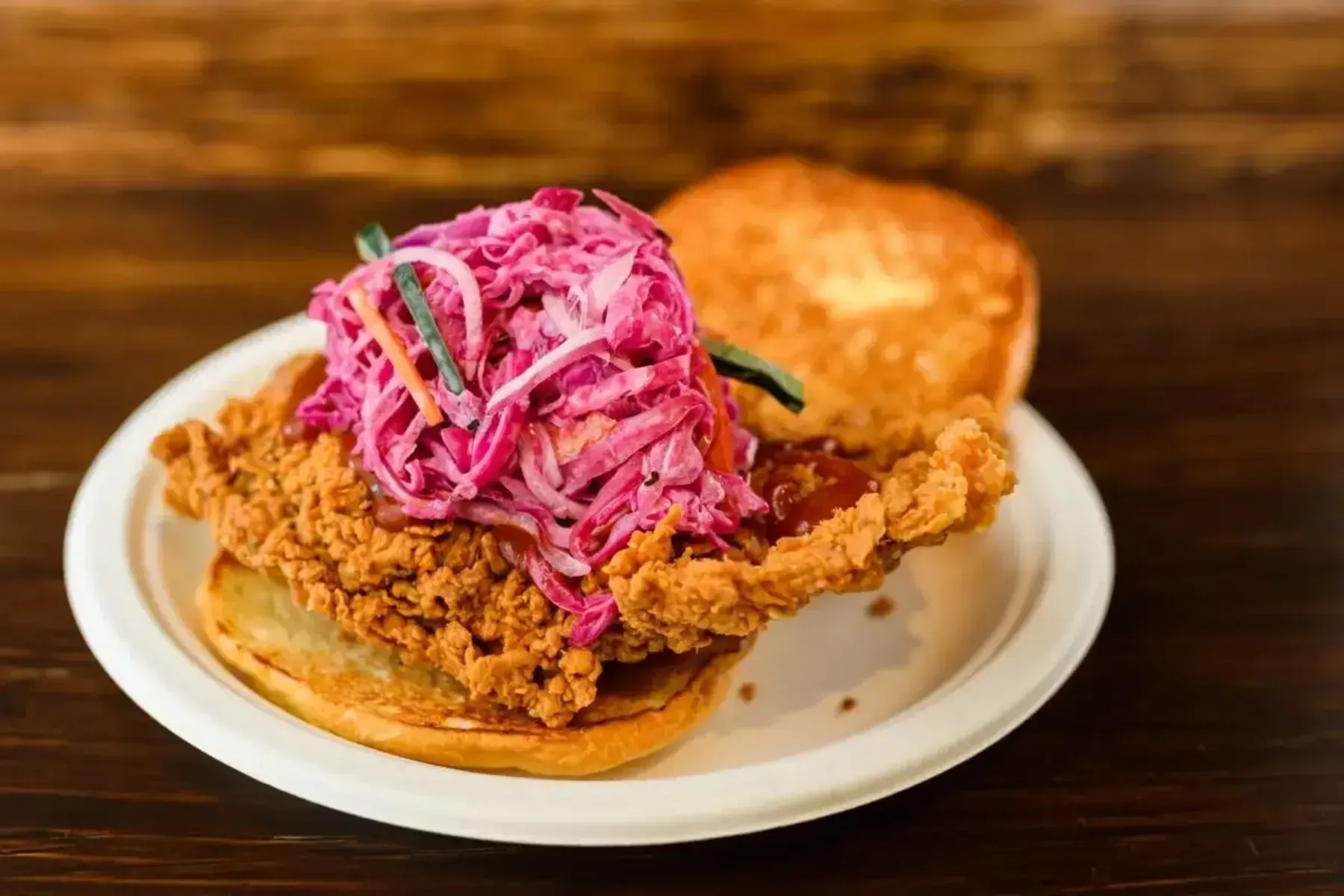 Plate of pasta with greens and meat, with other dishes in the background.