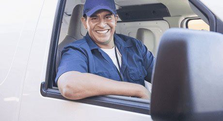 a driver sitting in a truck and smiling
