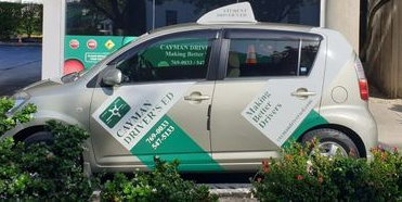 A White and Green Car is Parked in Front of a Building