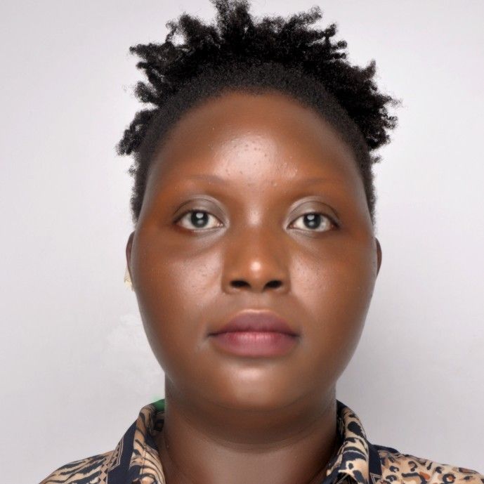 A woman with short hair is wearing a leopard print shirt