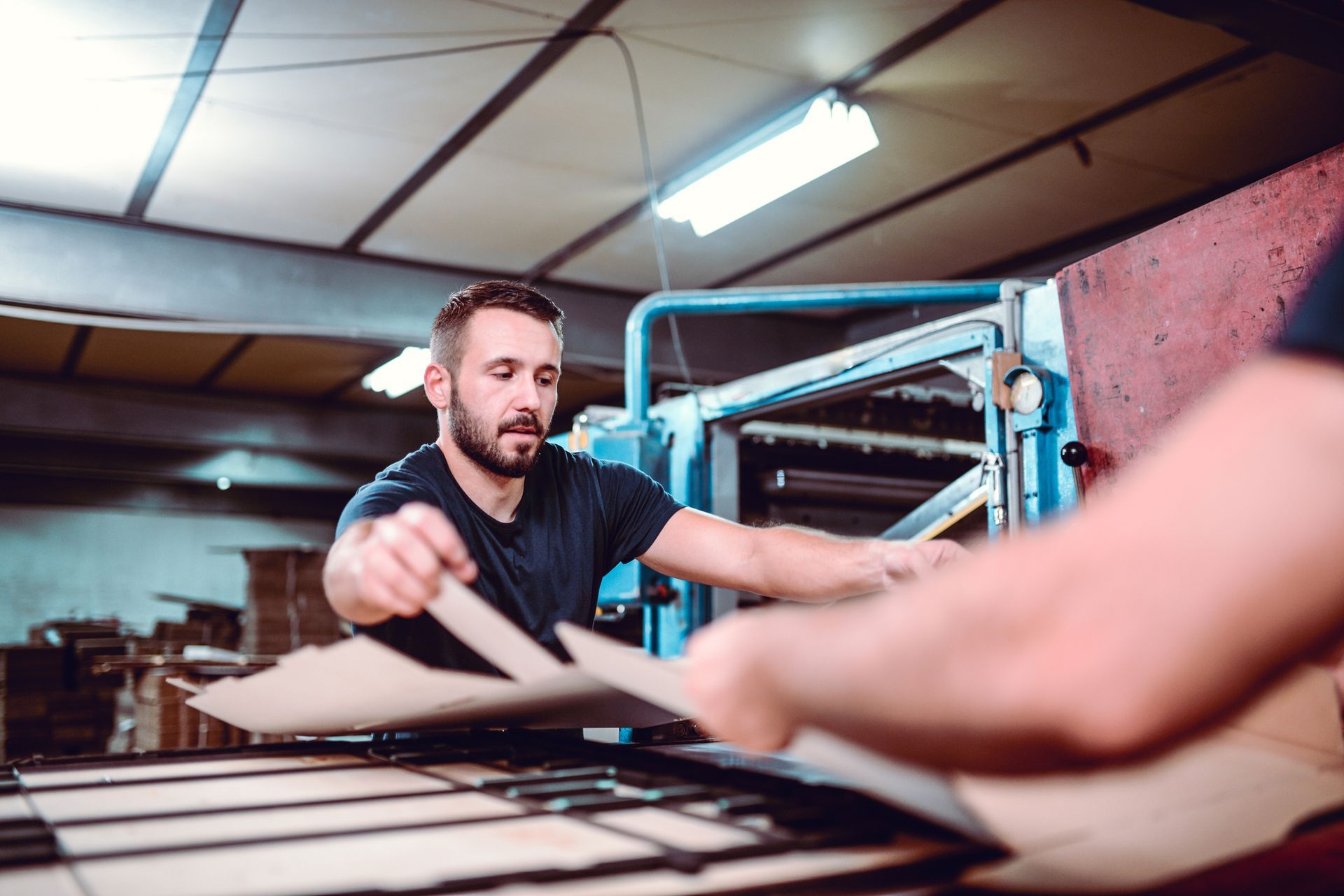 A man is working on a machine in a factory.