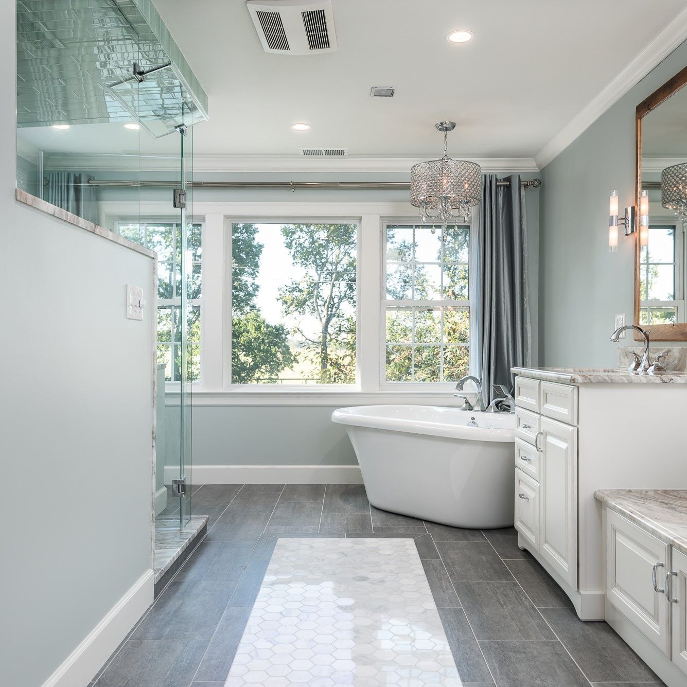 A bathroom with a bathtub and a mirror