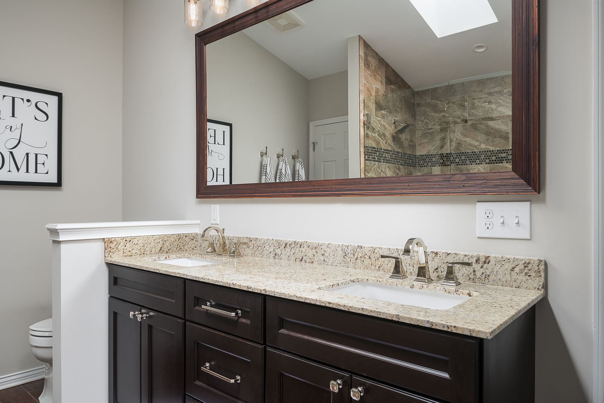 A bathroom with two sinks and a large mirror.