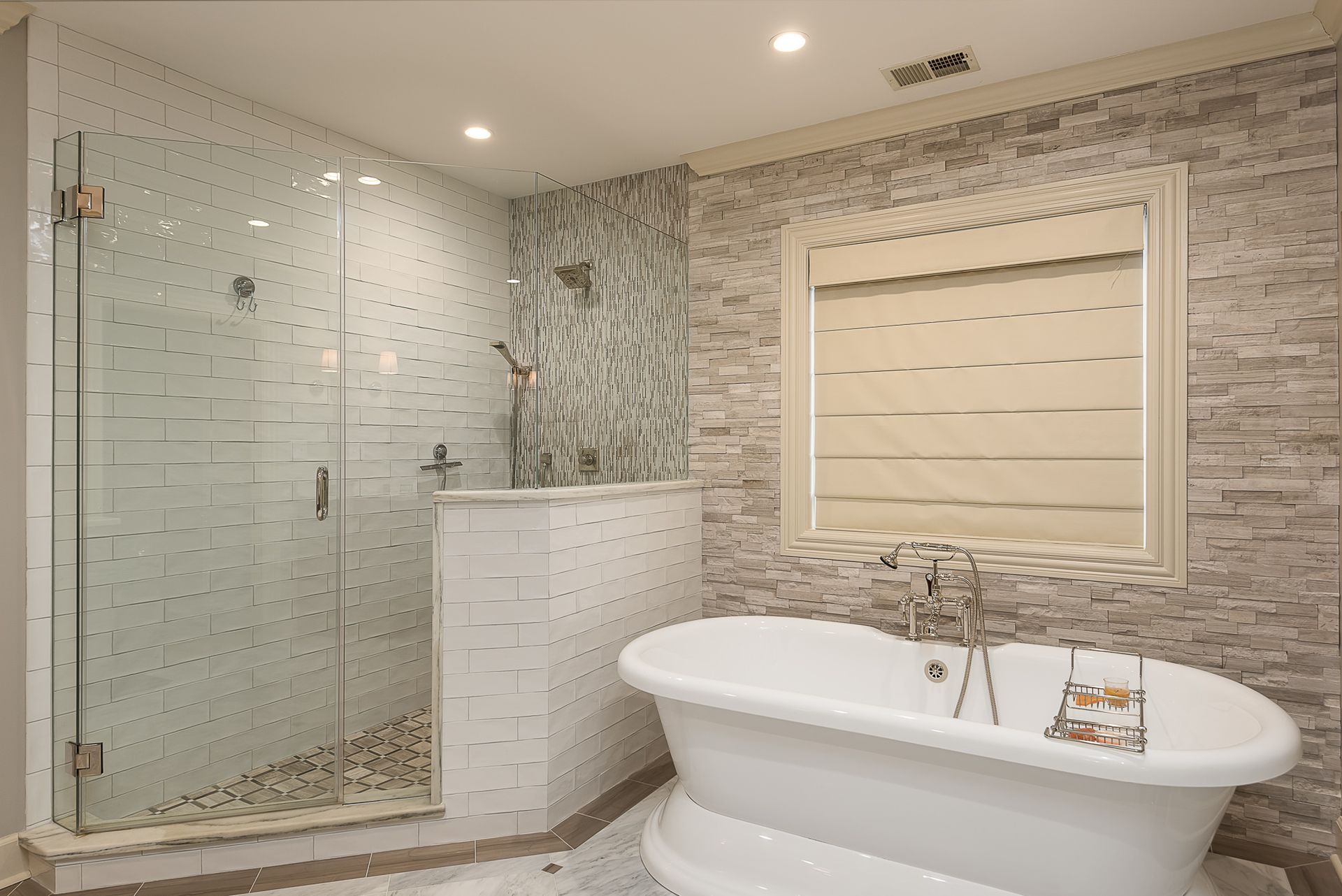 A bathroom with a tub , shower and window.