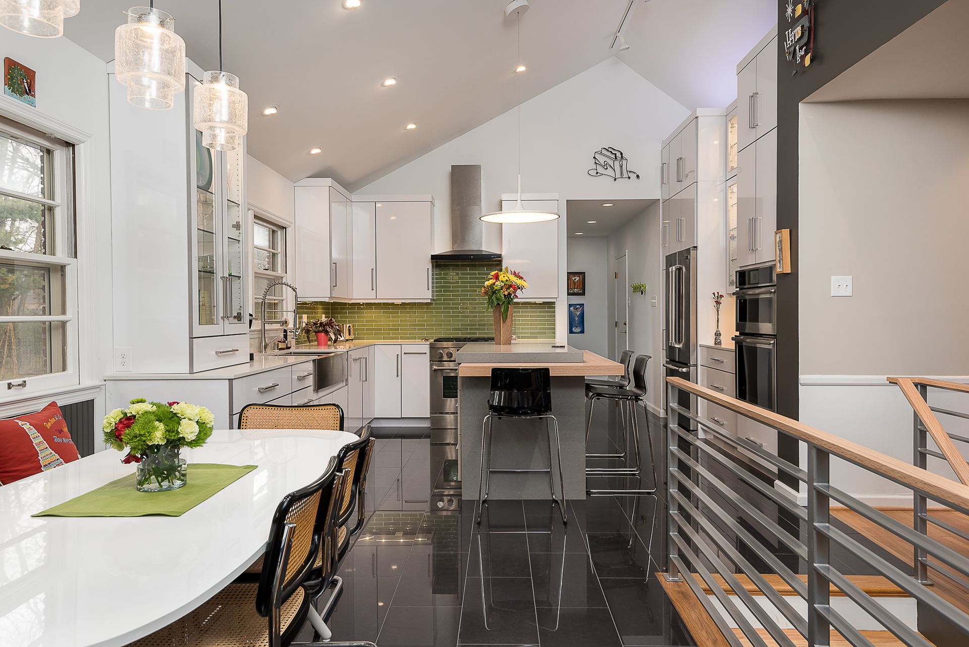 A kitchen with a table and chairs in it and a vaulted ceiling.