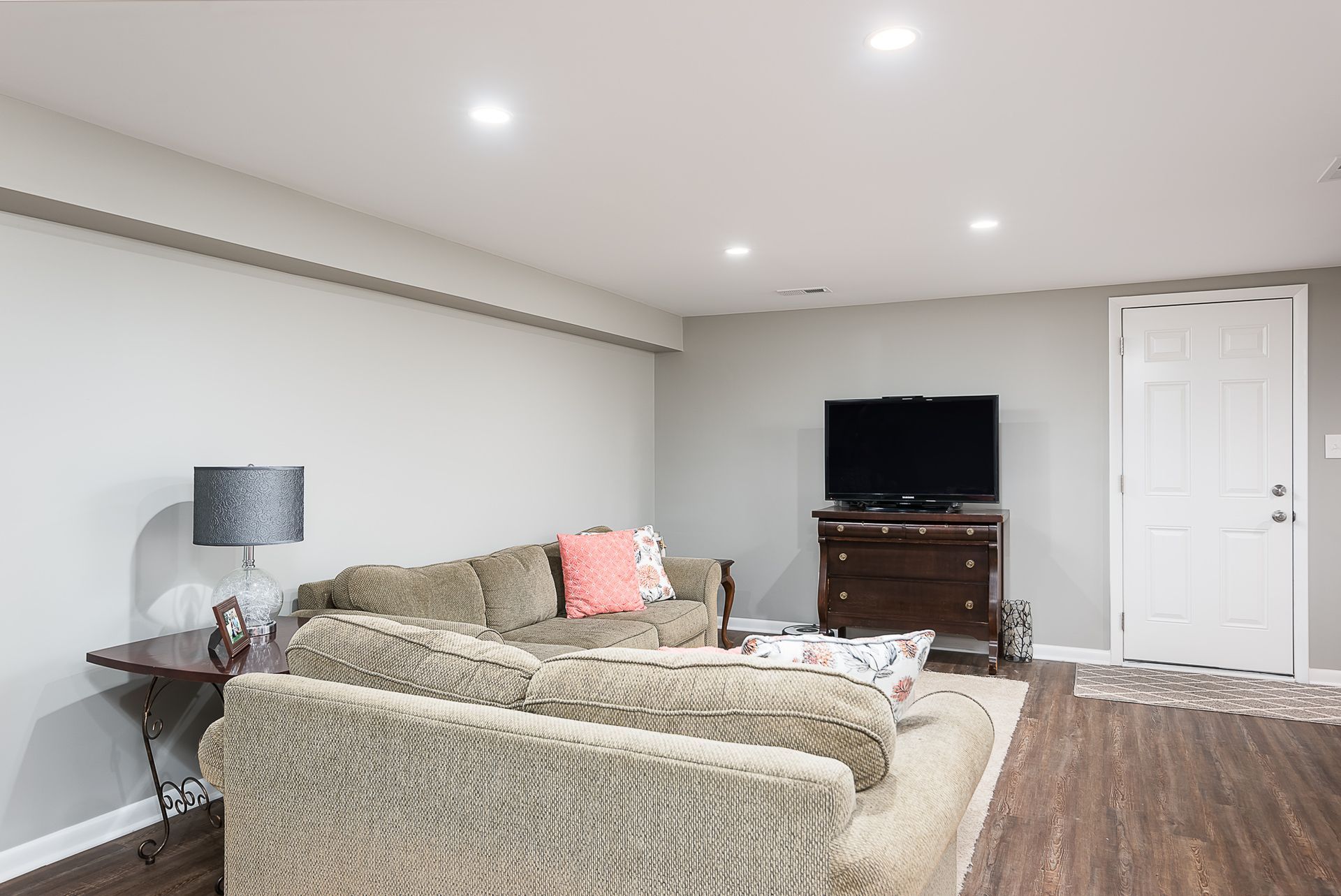 A living room with a couch and a flat screen tv.