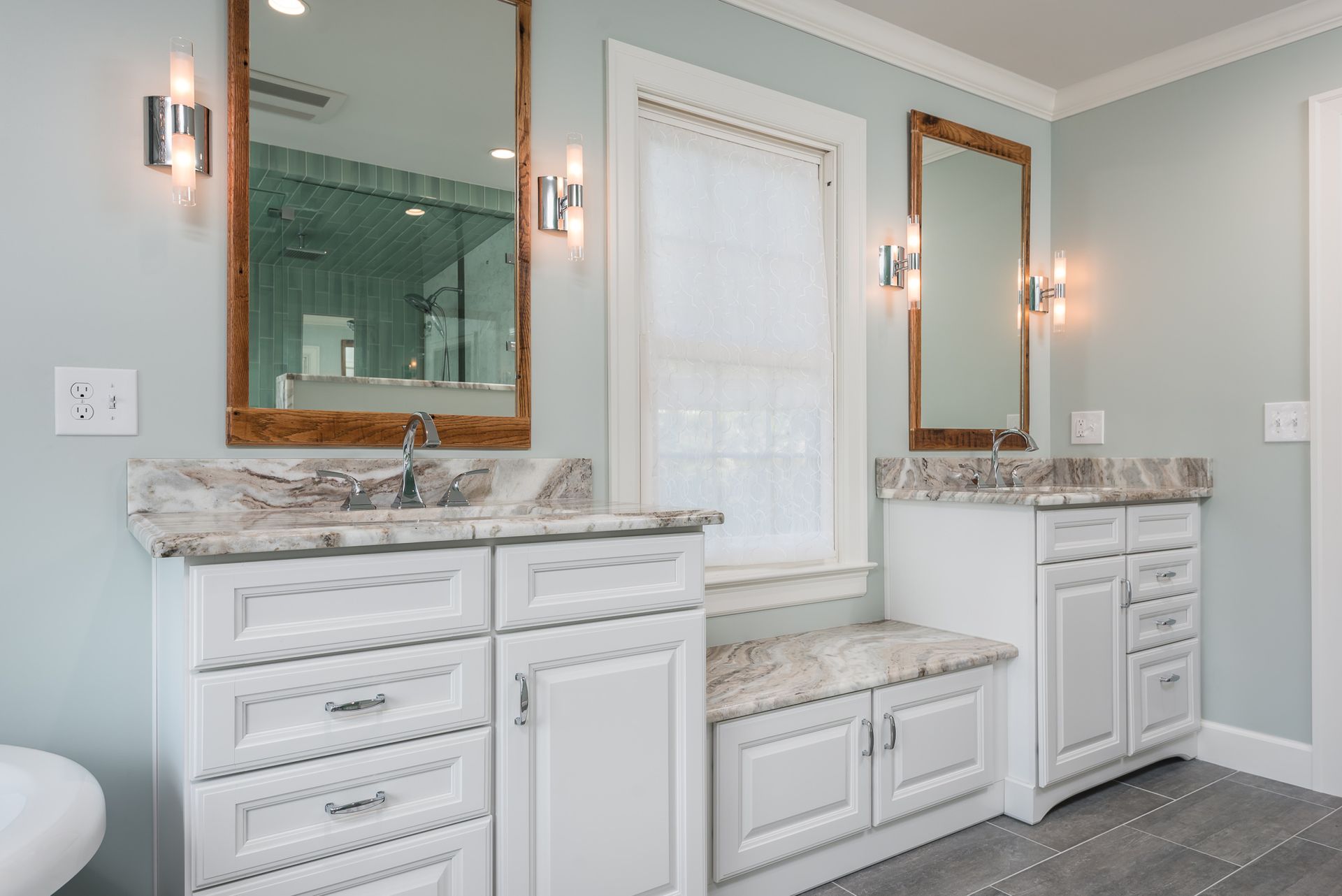 A bathroom with two sinks and two mirrors.