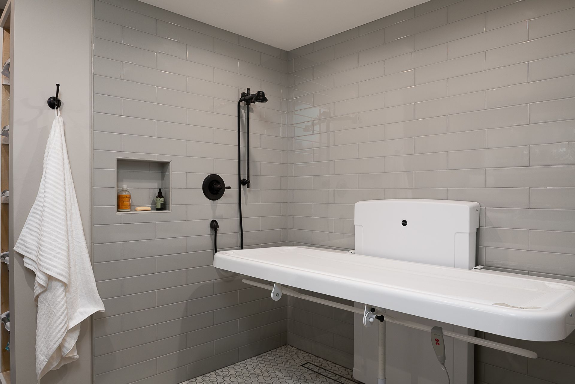 A bathroom with a sink and a shower.