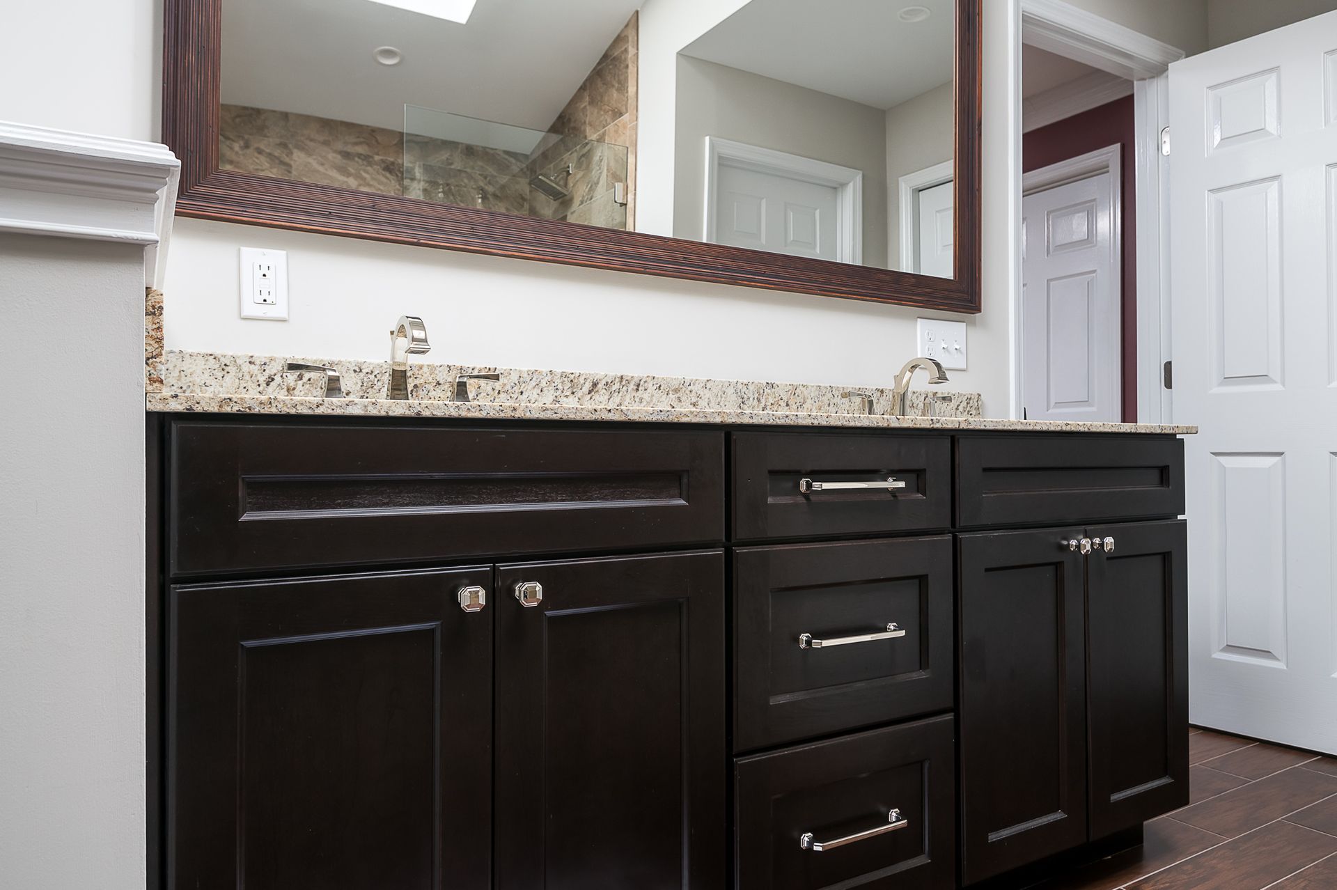 A bathroom with two sinks and a large mirror