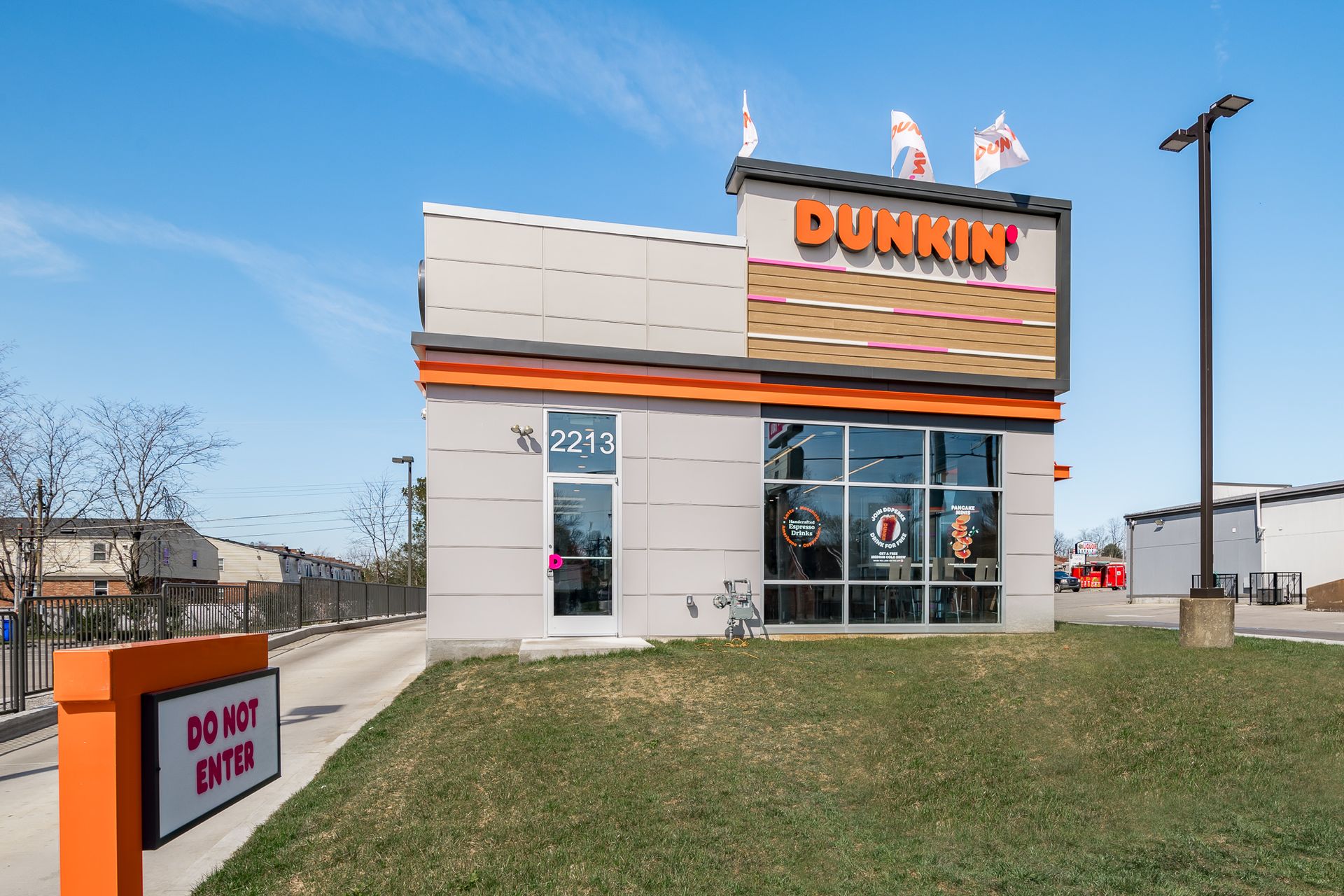 A dunkin donuts restaurant with a sign that says do not enter