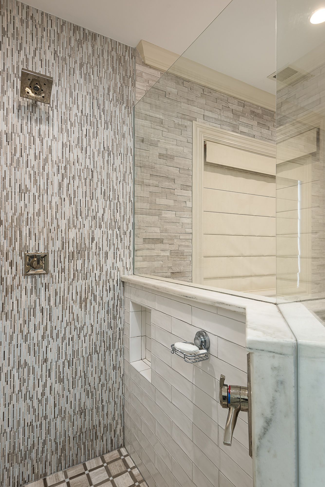 A bathroom with a walk in shower and a bathtub.