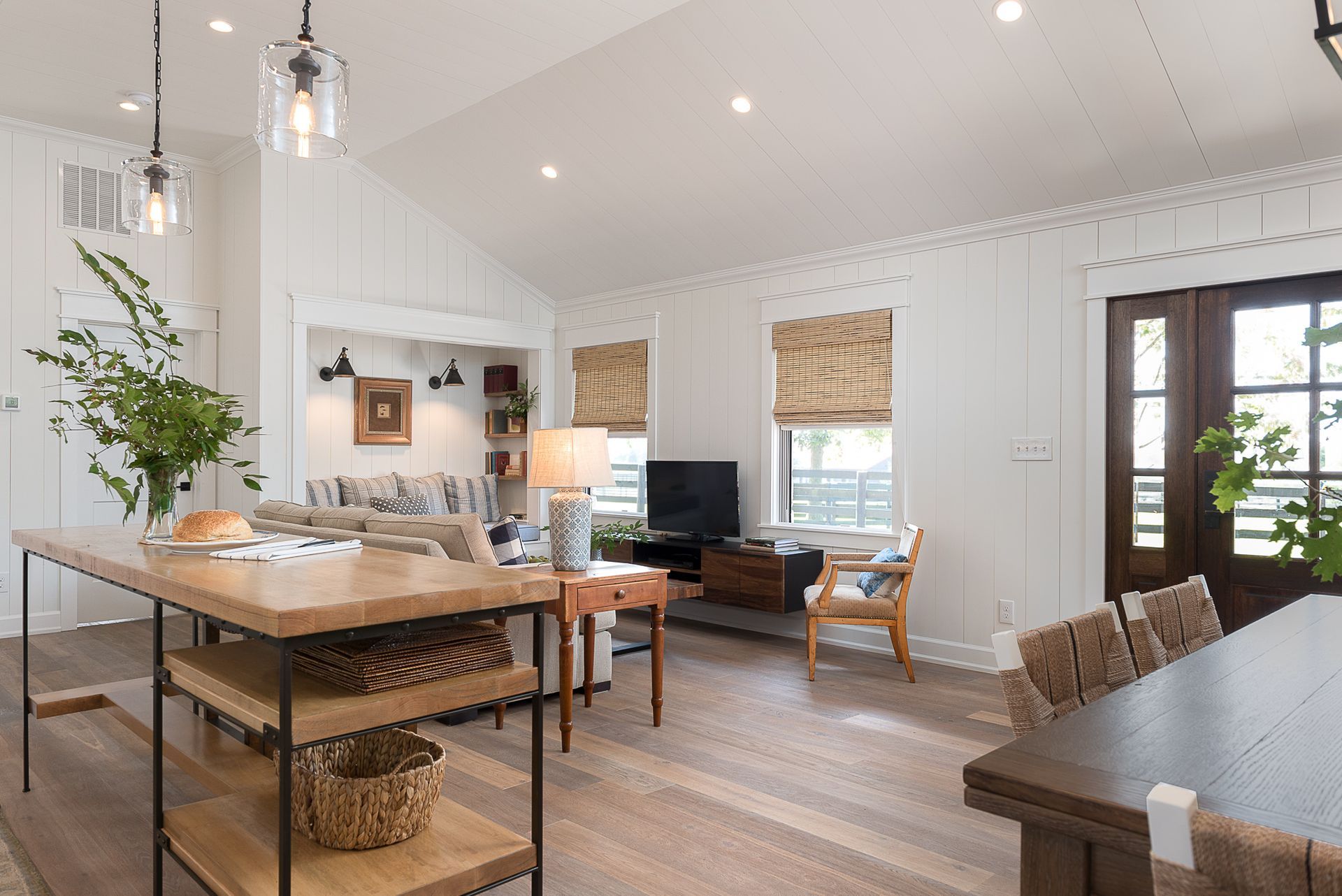 A living room with a table , chairs , and a television.