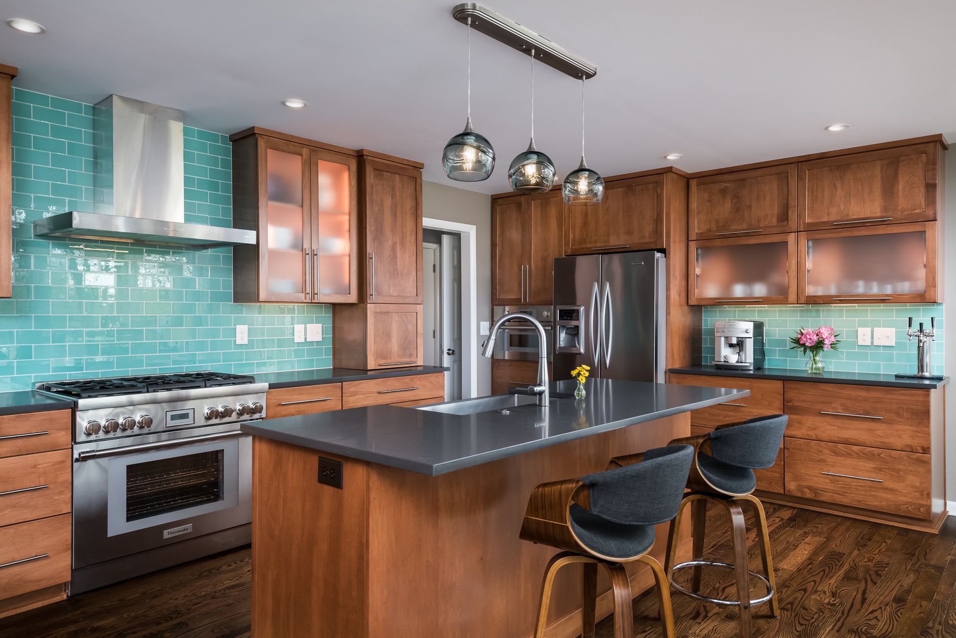 A kitchen with wooden cabinets , stainless steel appliances , and a large island.