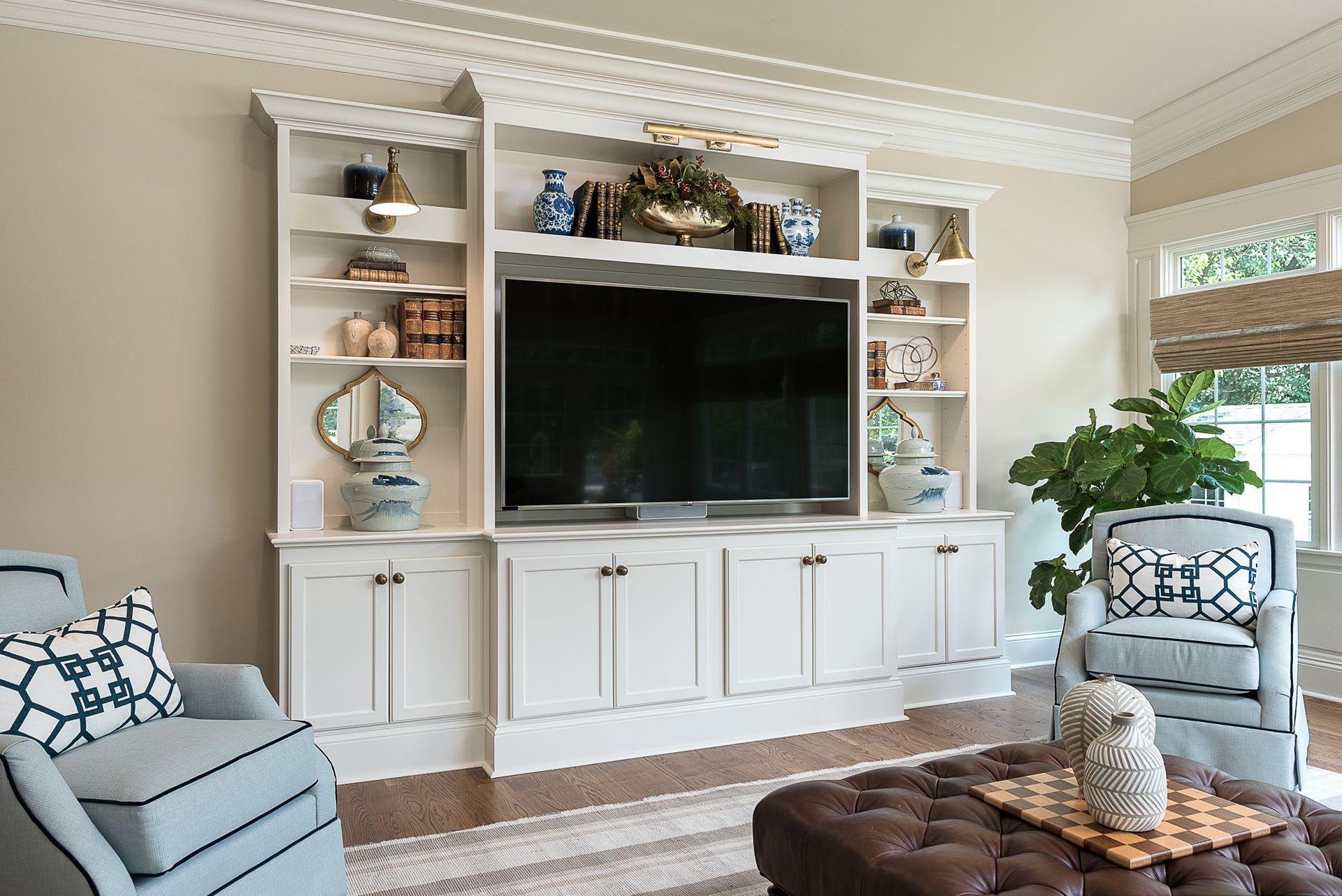 A living room with a large flat screen tv on the wall.