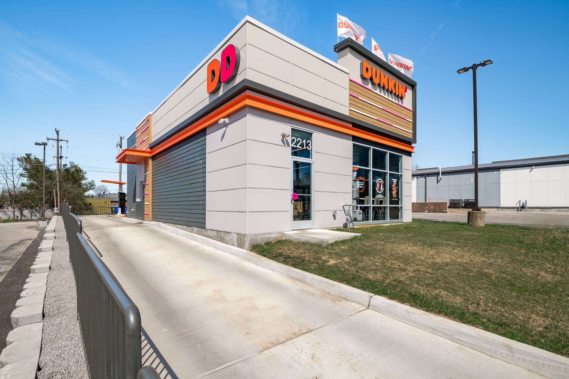 A dunkin donuts restaurant is located on the side of the road