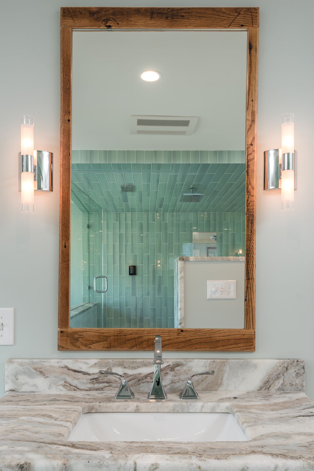 A bathroom sink with a large mirror above it