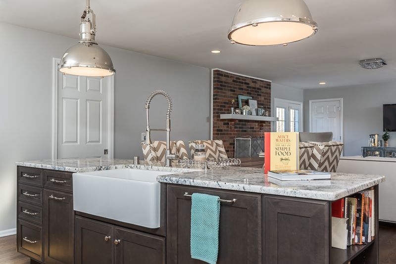 A kitchen with a large island and a sink.