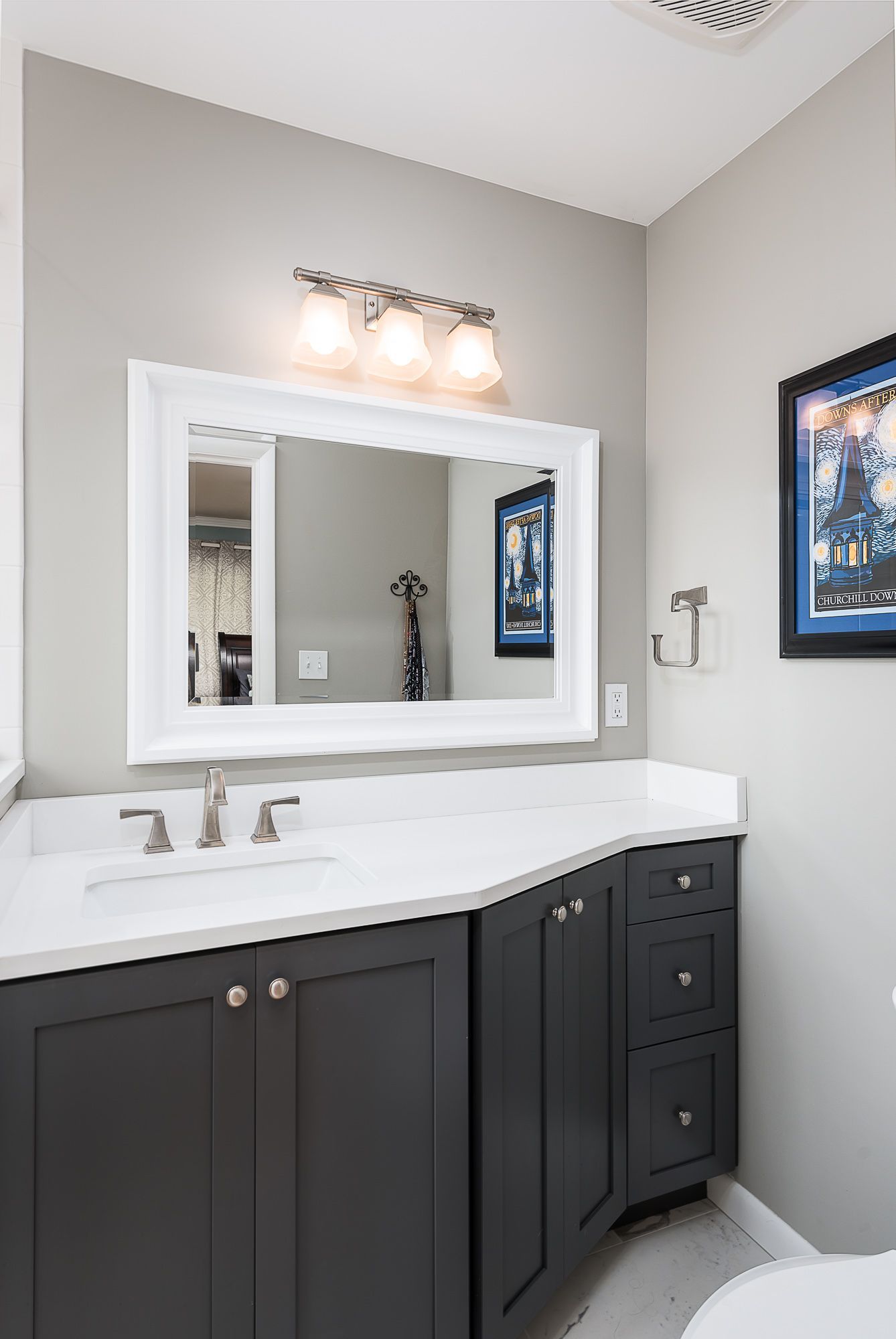 A bathroom with a sink , mirror and toilet.