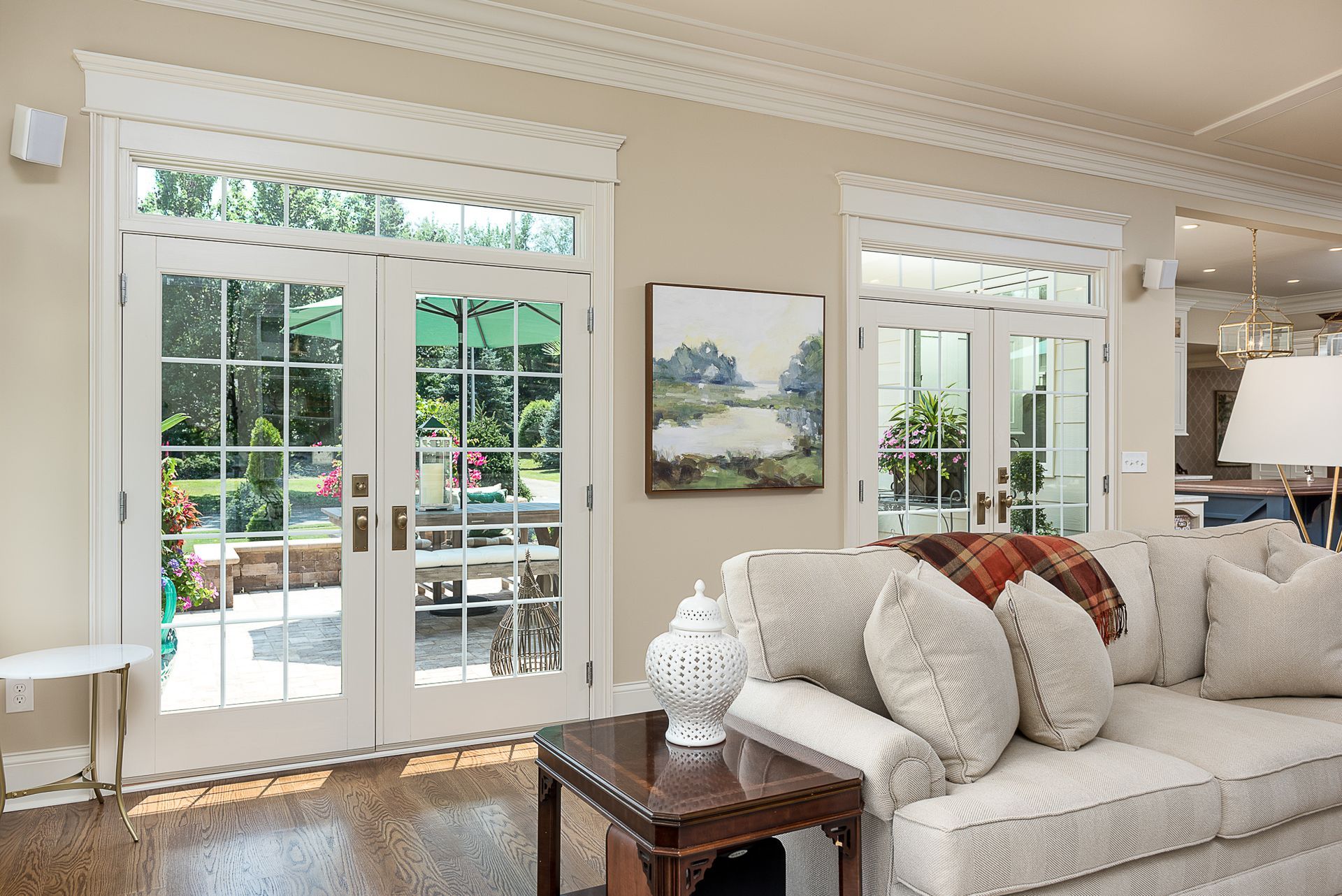 A living room with a couch , table , and sliding glass doors.