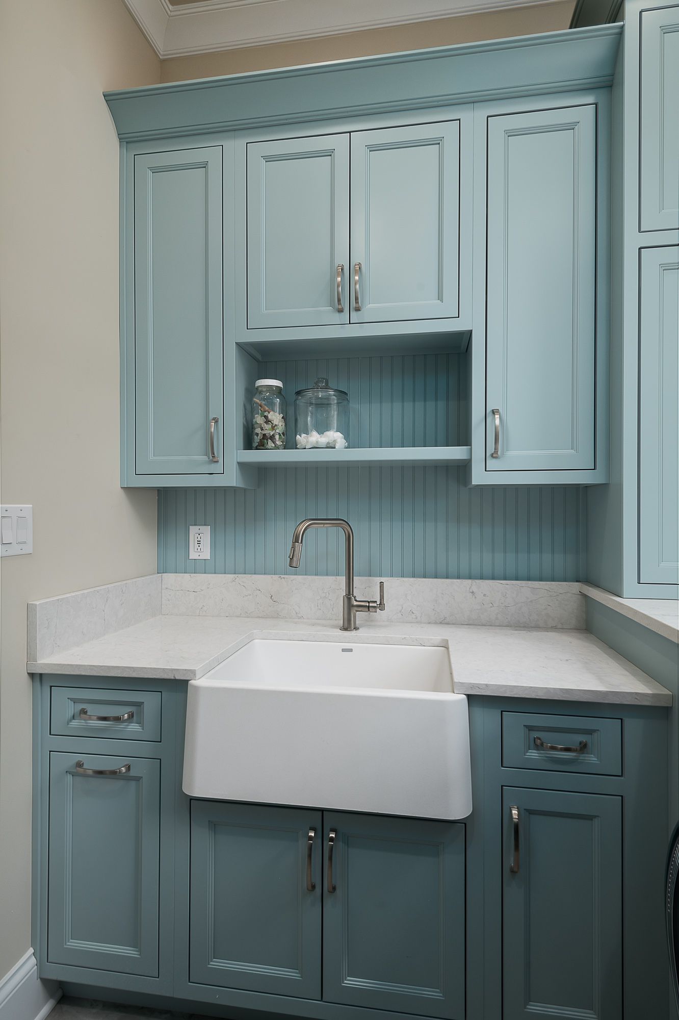 A kitchen with blue cabinets and a white sink