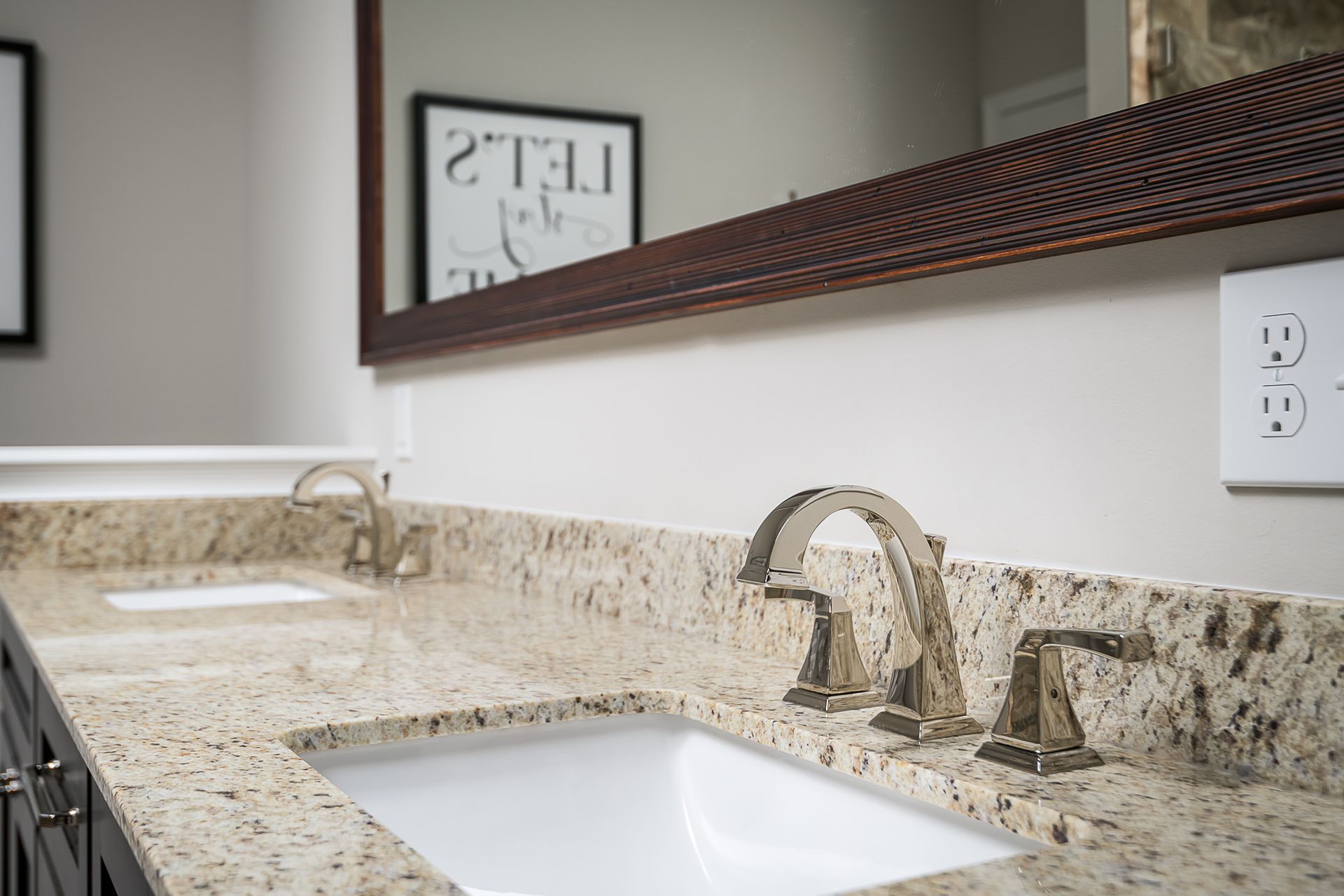 A bathroom with two sinks and a mirror.