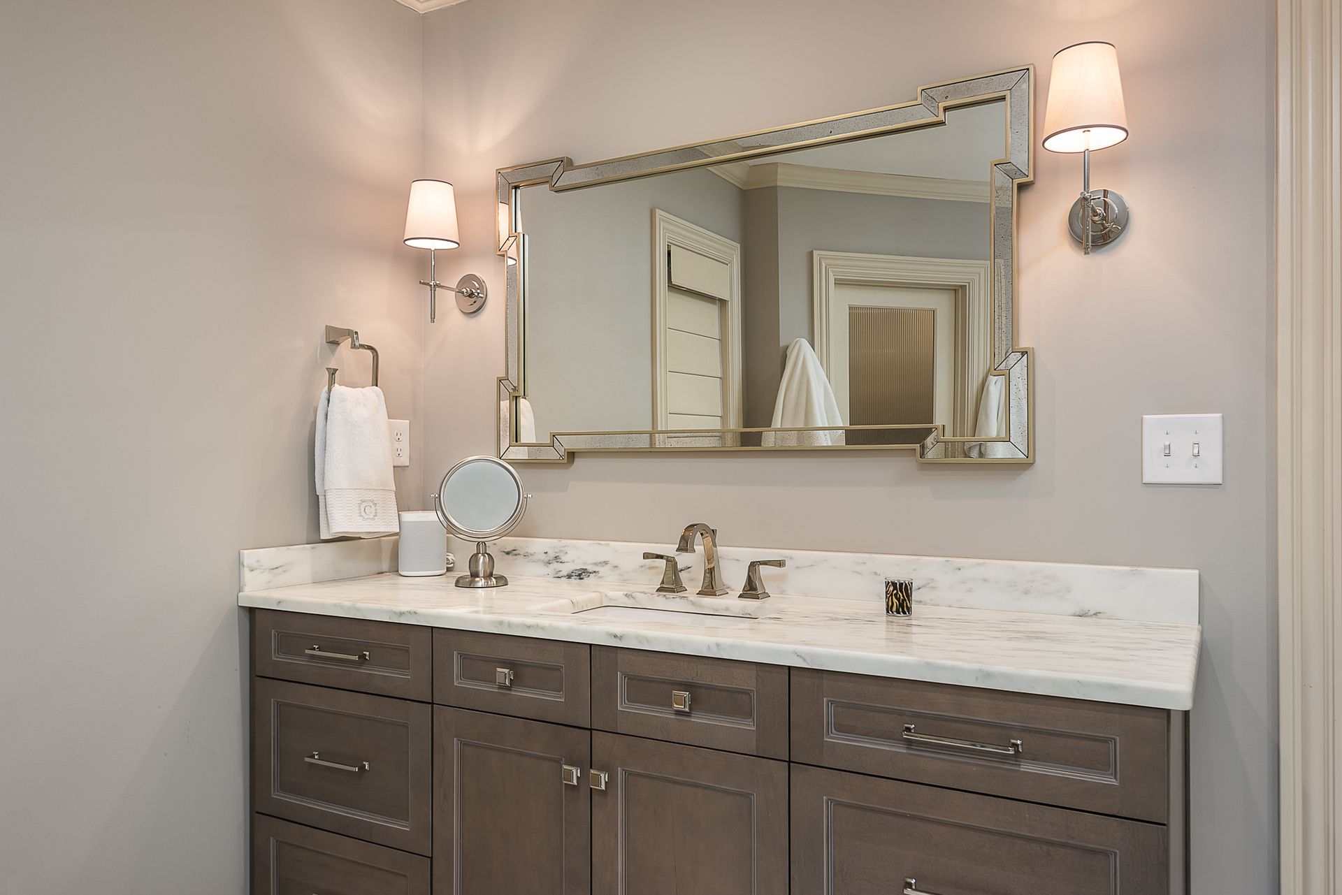 A bathroom with two sinks and a large mirror