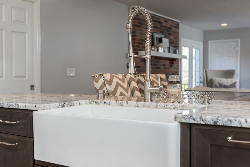 A kitchen sink with a faucet and a bowl on top of it.