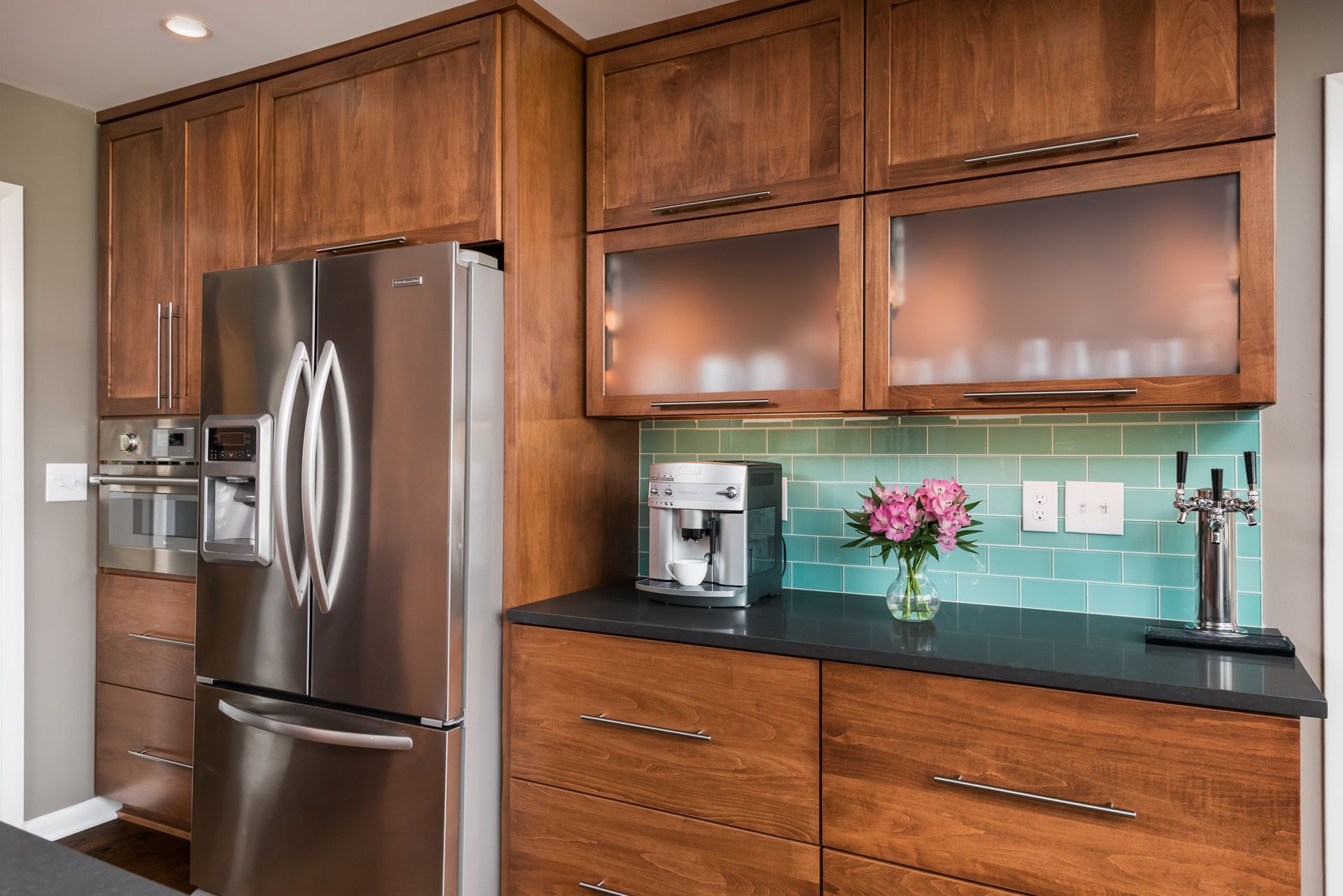 A kitchen with stainless steel appliances and wooden cabinets.