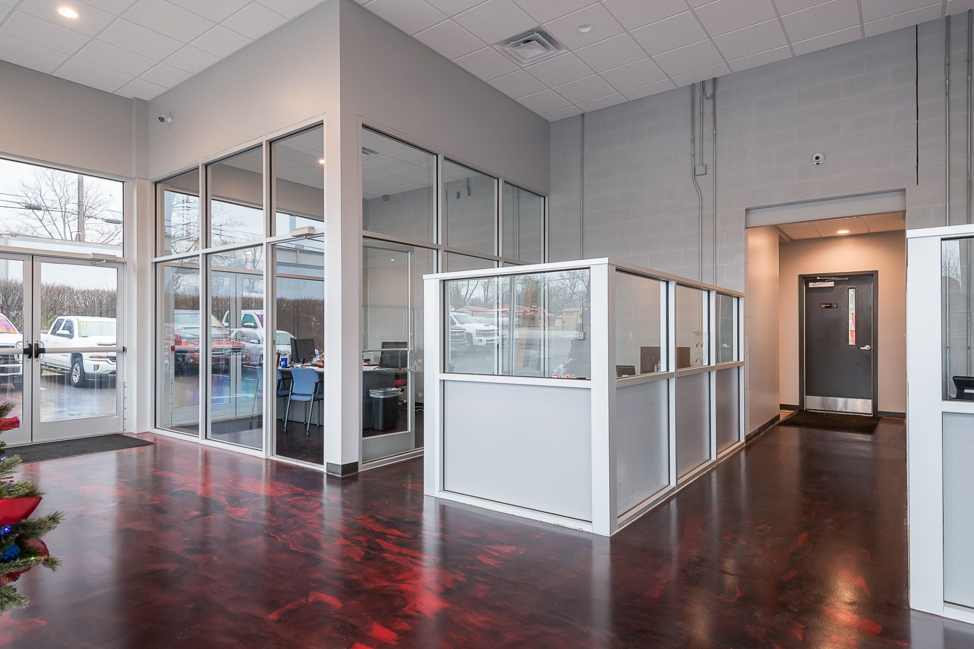 A large room with a lot of windows and cubicles