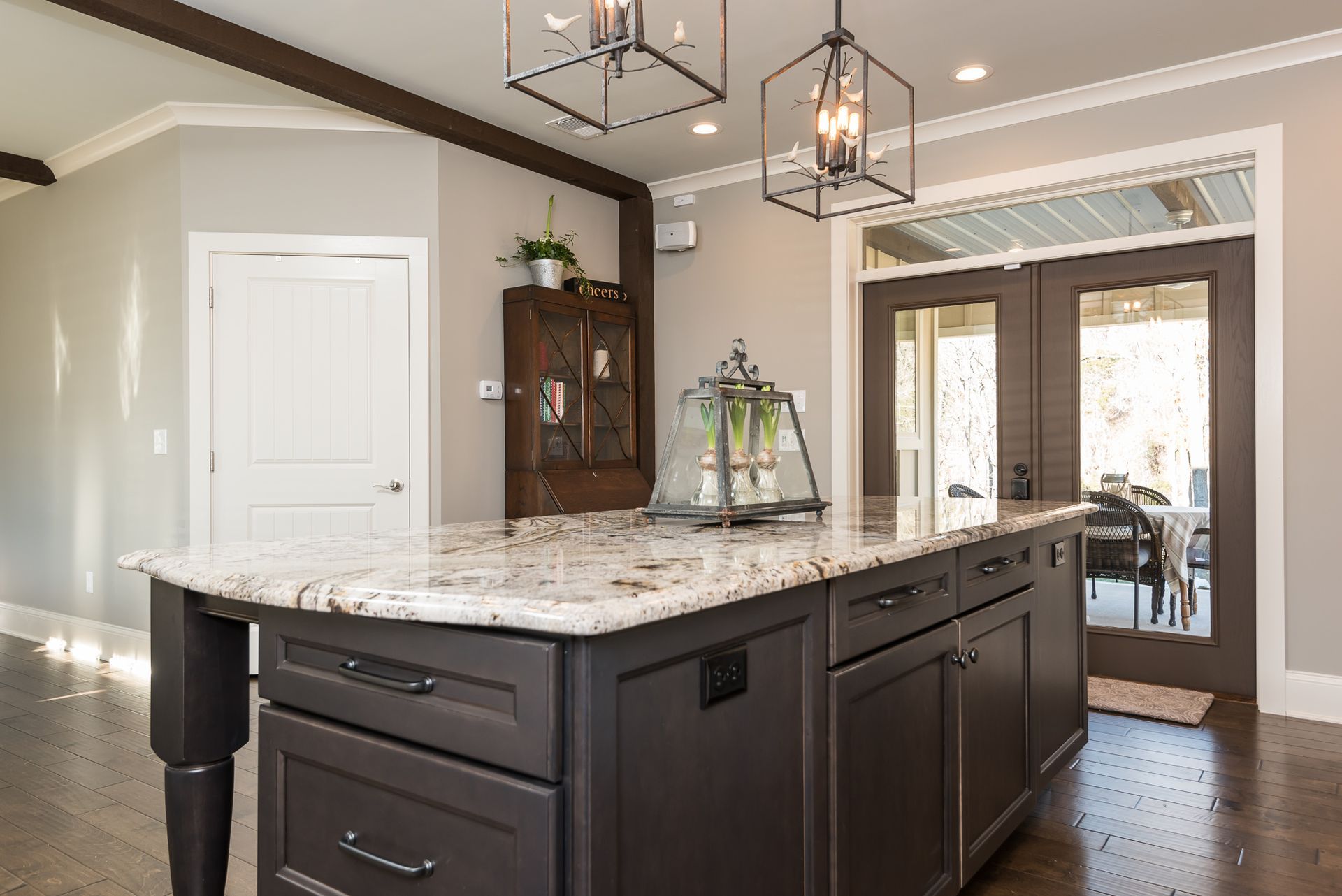 A kitchen with a large island and granite counter tops.