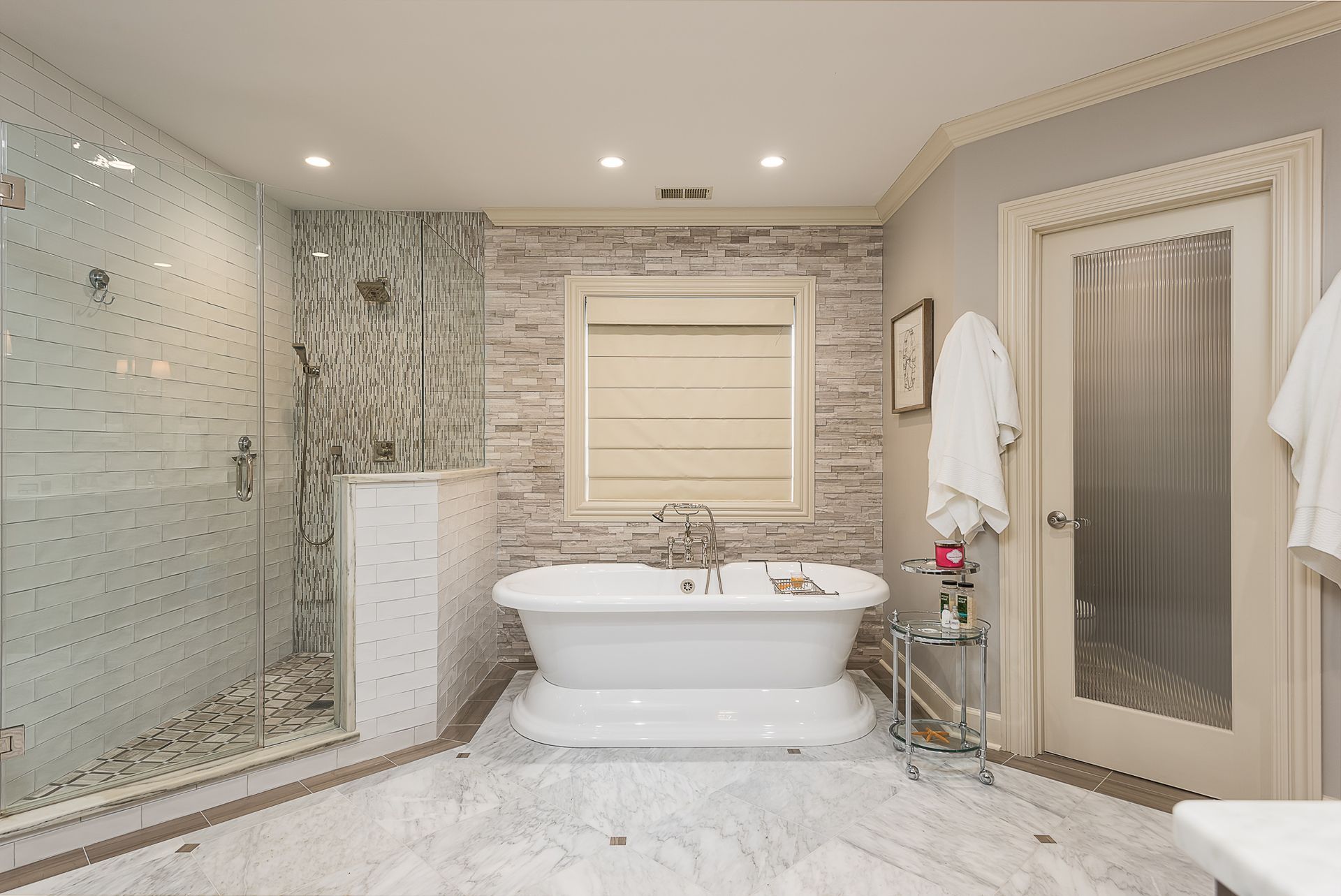 A bathroom with a tub and a walk in shower