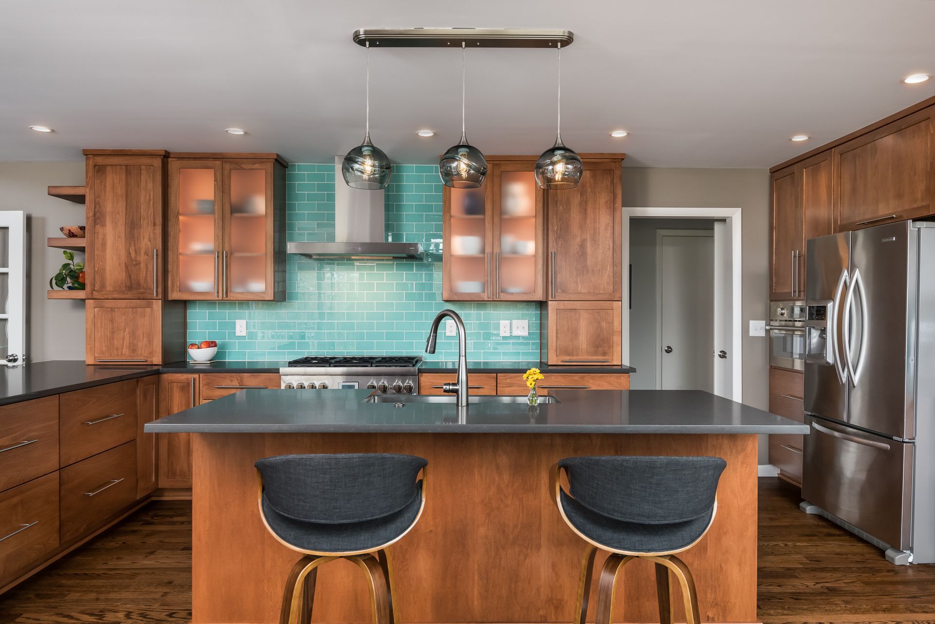 A kitchen with wooden cabinets , stainless steel appliances , and a large island.