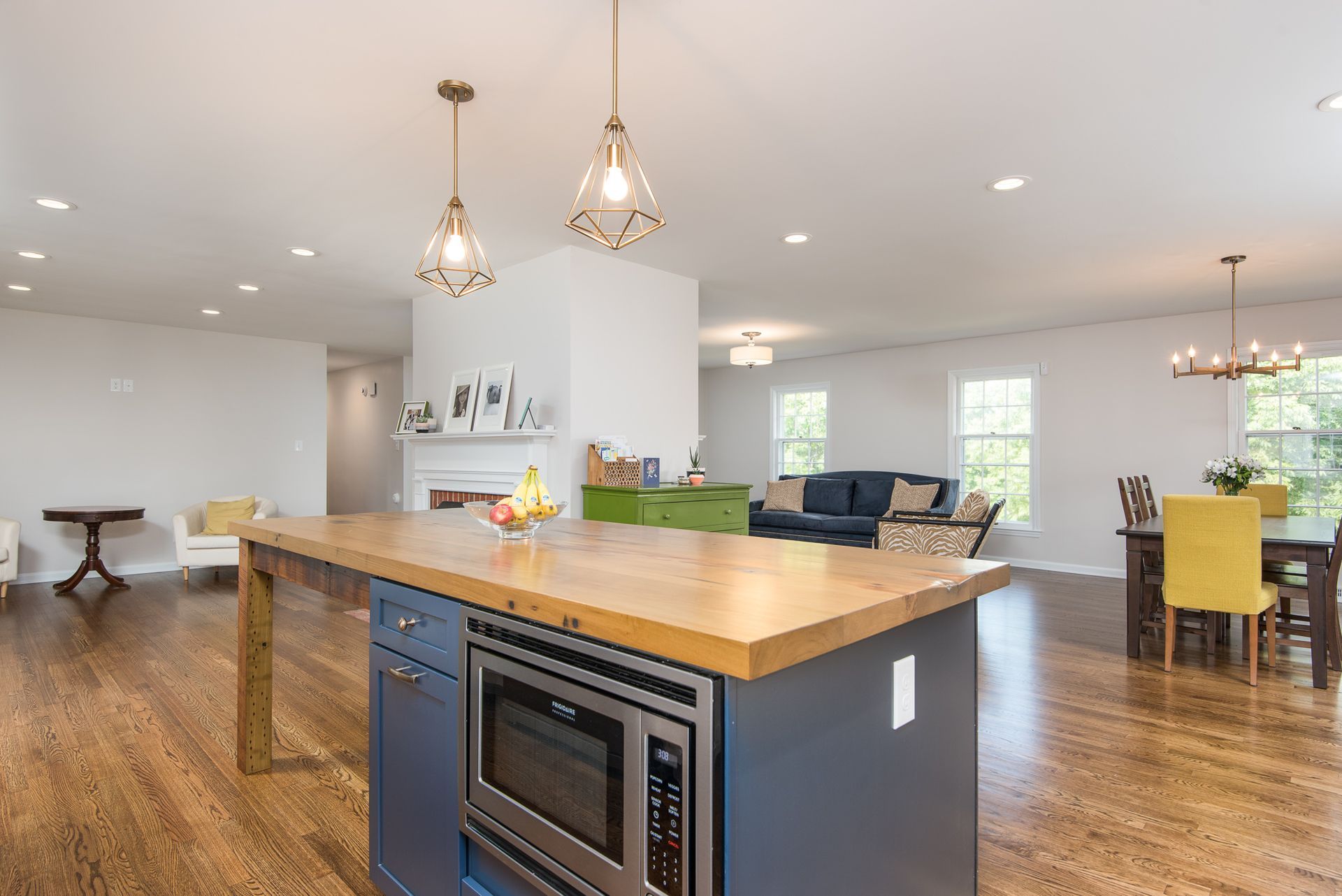 A kitchen with a large island and a microwave oven.