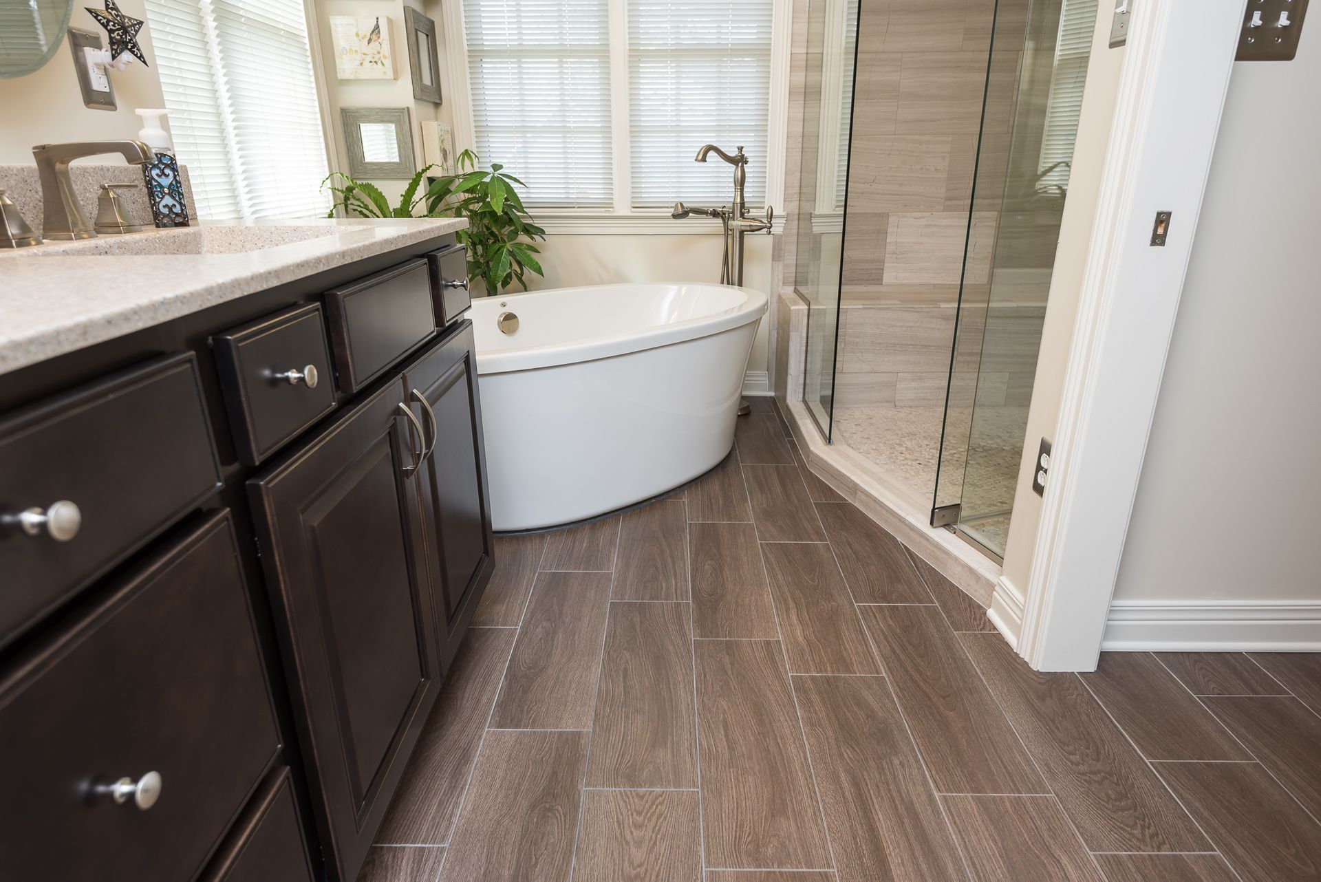 A bathroom with a tub , sink , and shower.