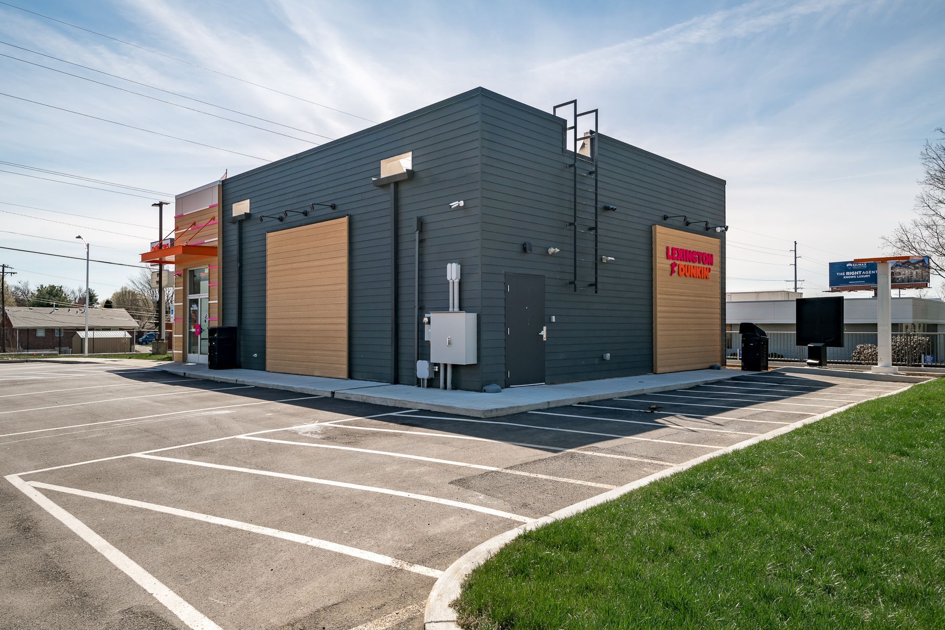 A large building with a parking lot in front of it.