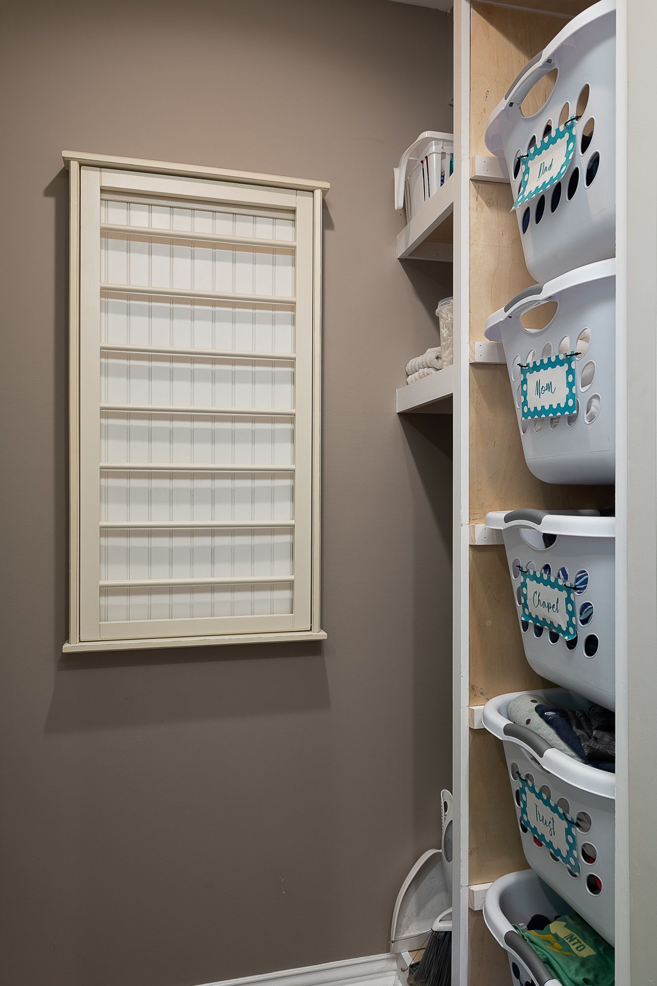 A laundry room with lots of baskets and a window.