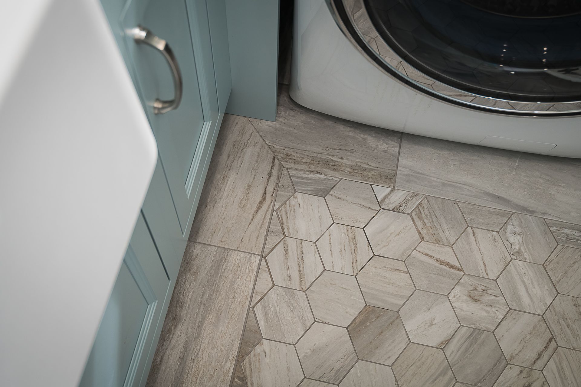 A laundry room with a washer and dryer and a sink.