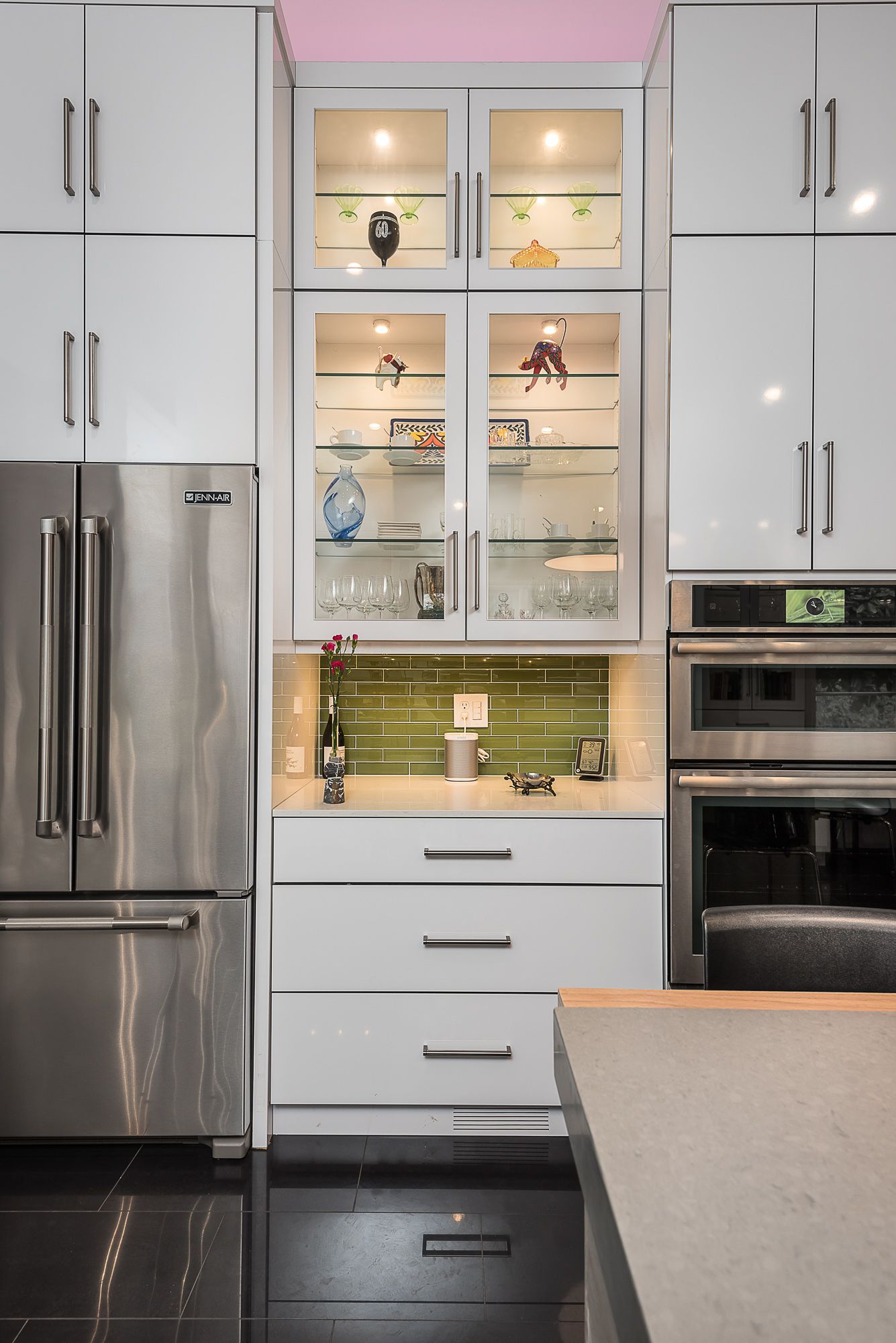 A kitchen with stainless steel appliances and white cabinets