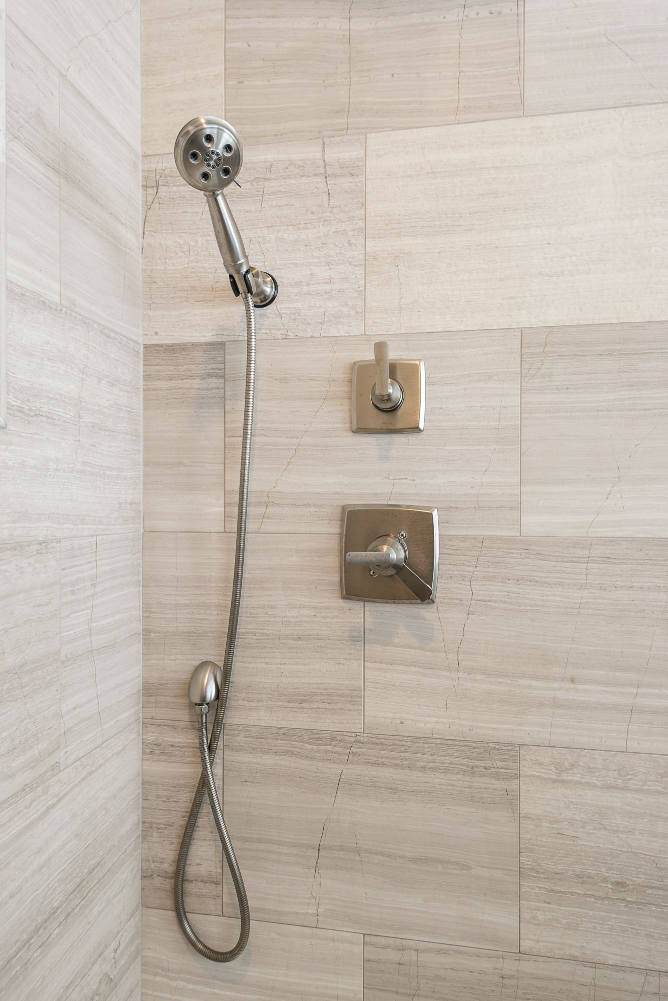 A close up of a shower head in a bathroom.