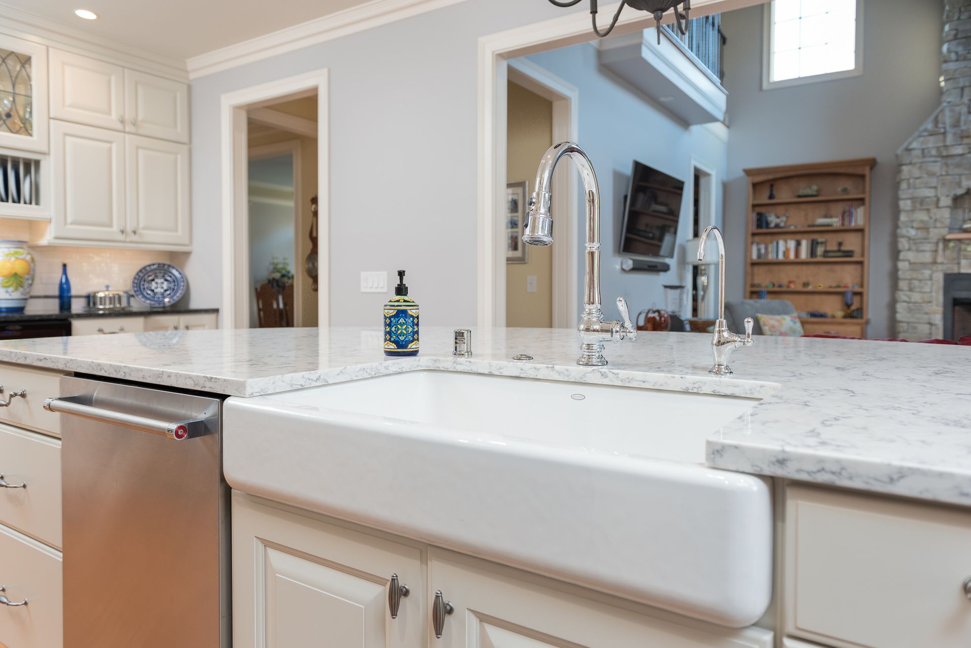 A kitchen with a large white sink and a dishwasher.