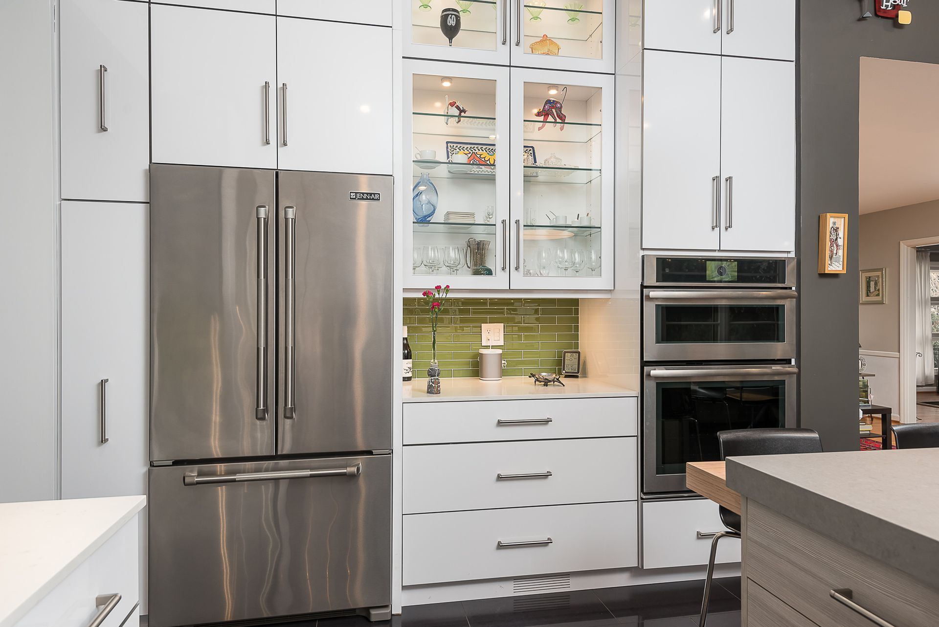 A kitchen with stainless steel appliances and white cabinets