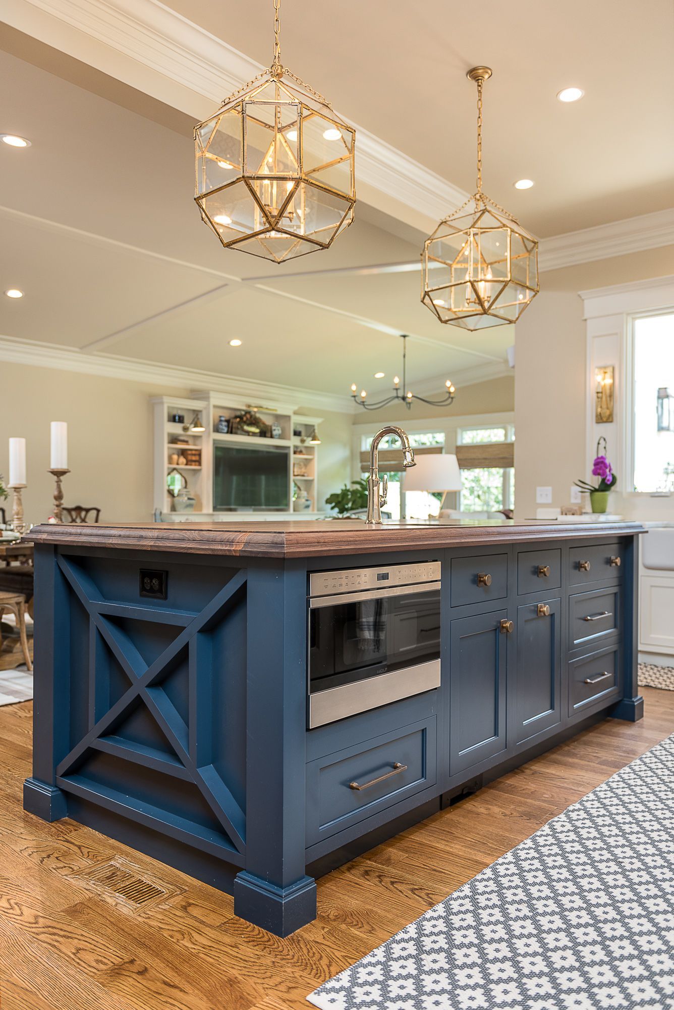 There is a large blue island in the middle of the kitchen.