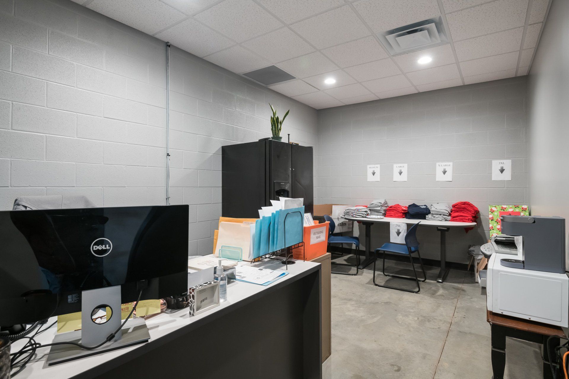 A dell computer is sitting on a desk in an office.