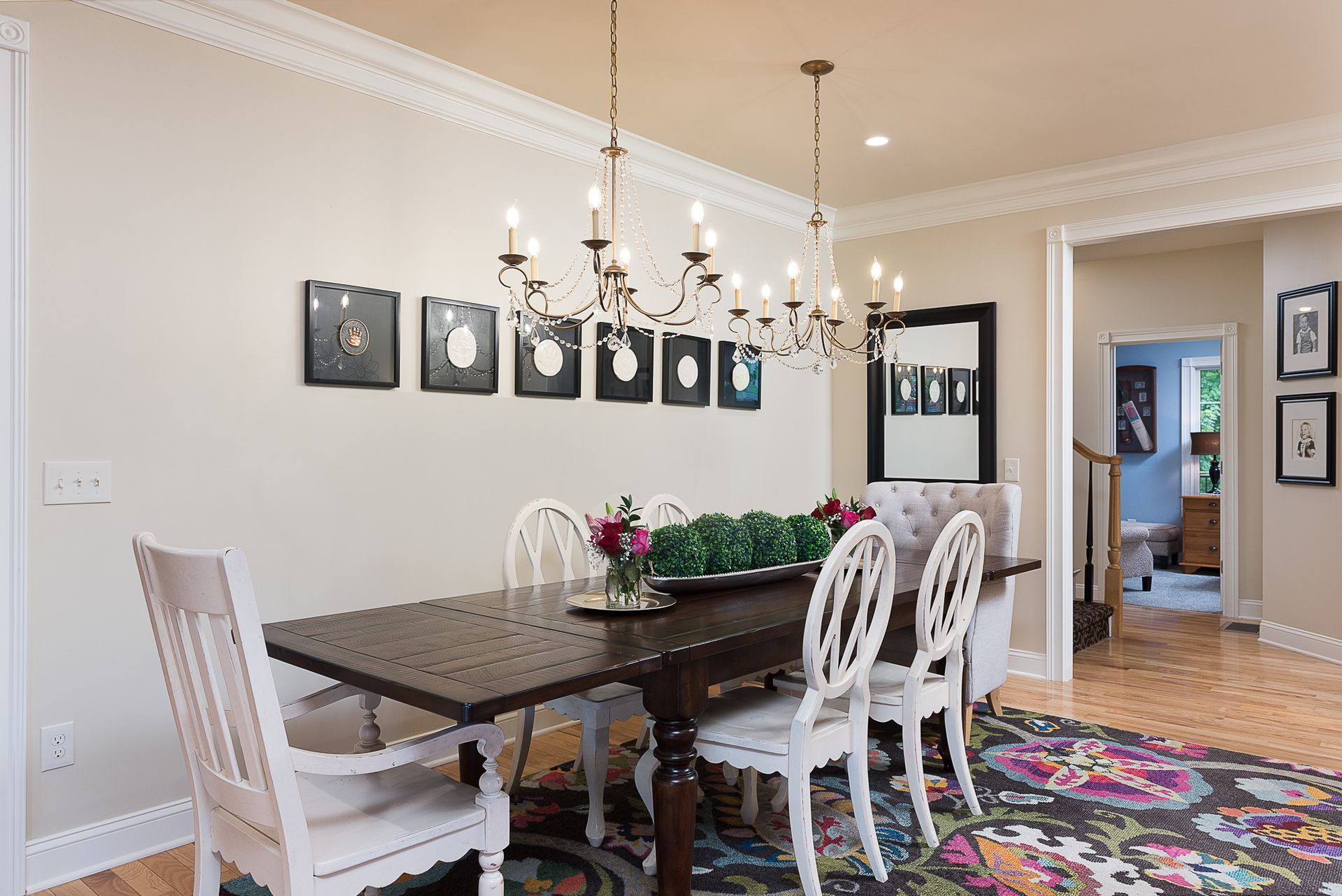 A dining room with a table and chairs and a chandelier.