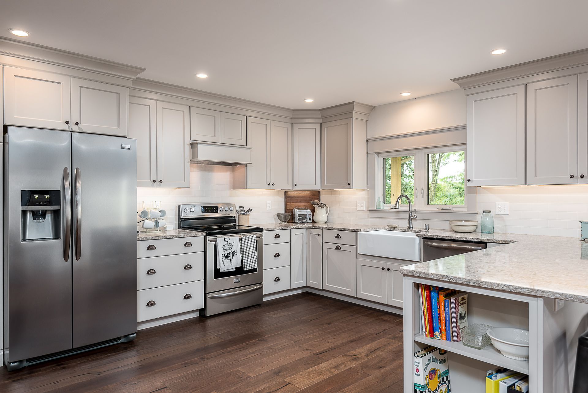 A kitchen with white cabinets and stainless steel appliances.