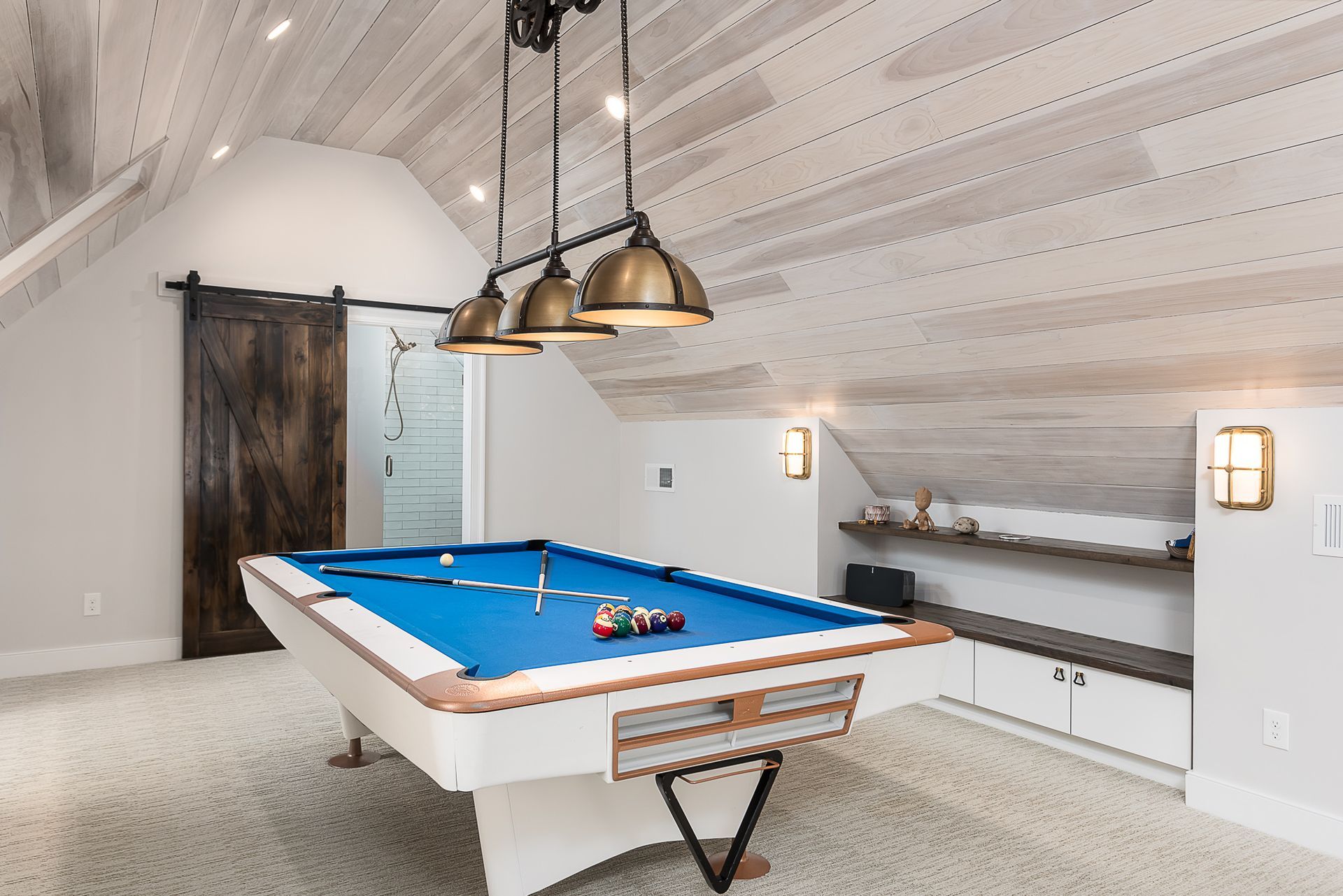 There is a pool table in the middle of the room.